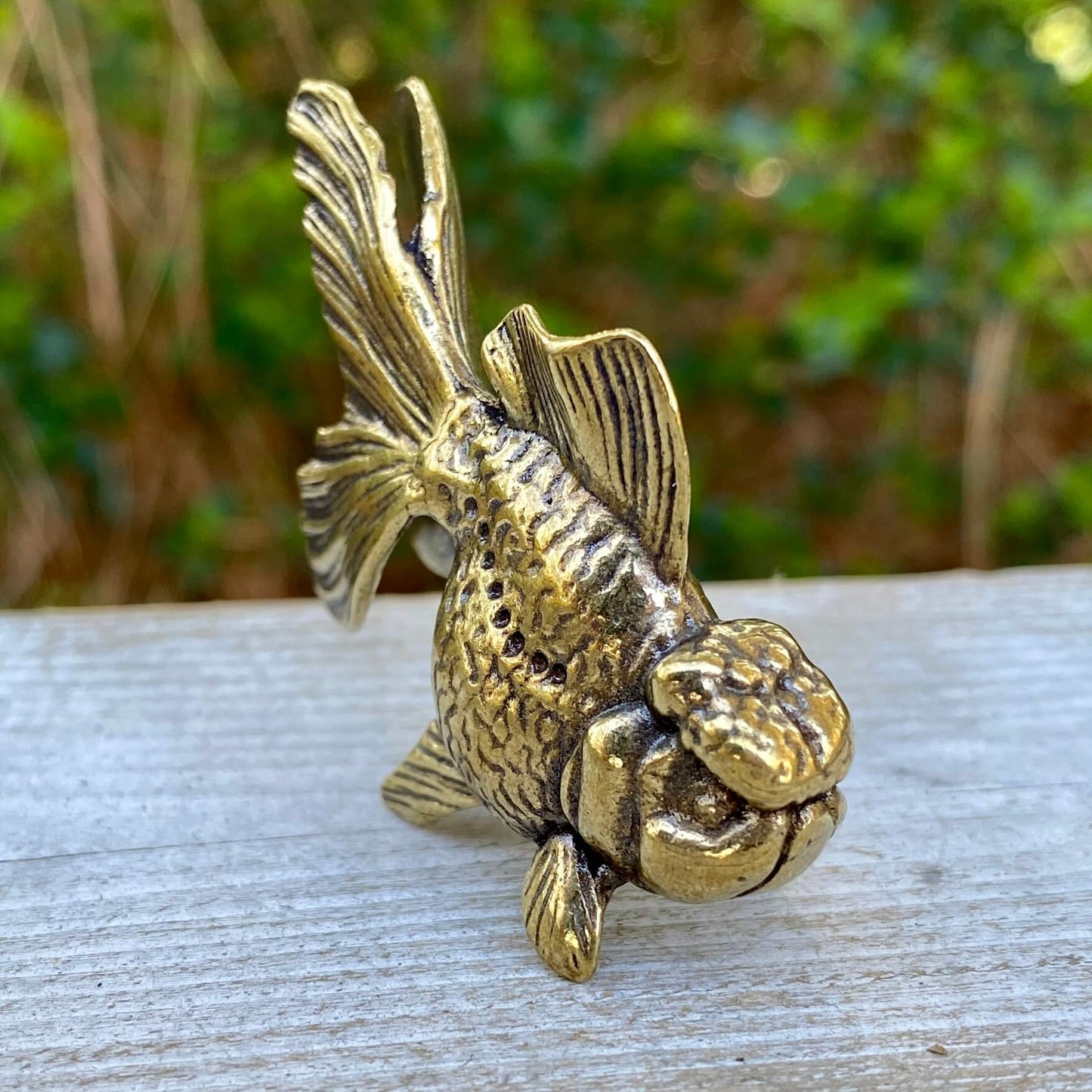 Solid brass goldfish sculpture by Wild Brass, symbolizing beauty, tranquility, and abundance, with detailed goldfish design.