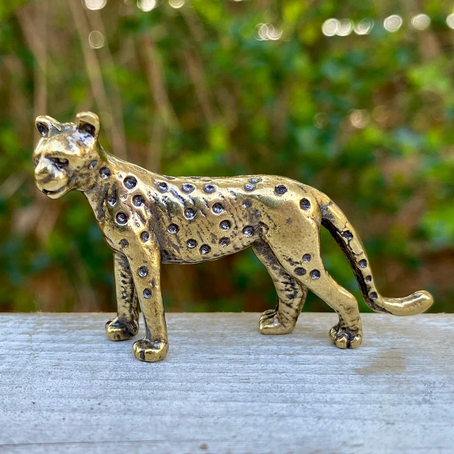 Solid brass leopard sculpture by Wild Brass, symbolizing grace, beauty, and power, showcasing intricate details and a polished finish.