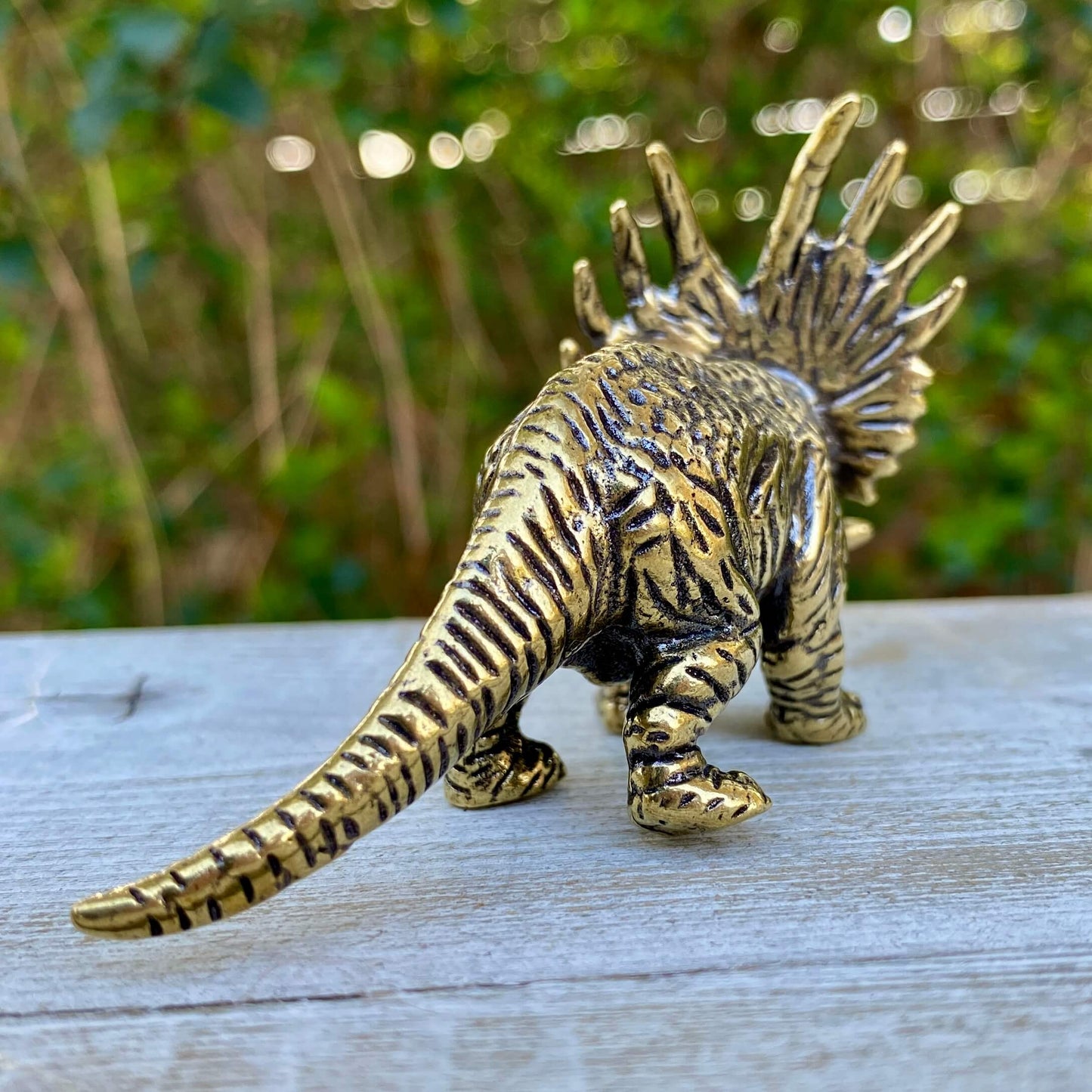 Solid brass Triceratops dinosaur sculpture by Wild Brass, symbolizing protection, strength, and courage, detailed and polished finish.