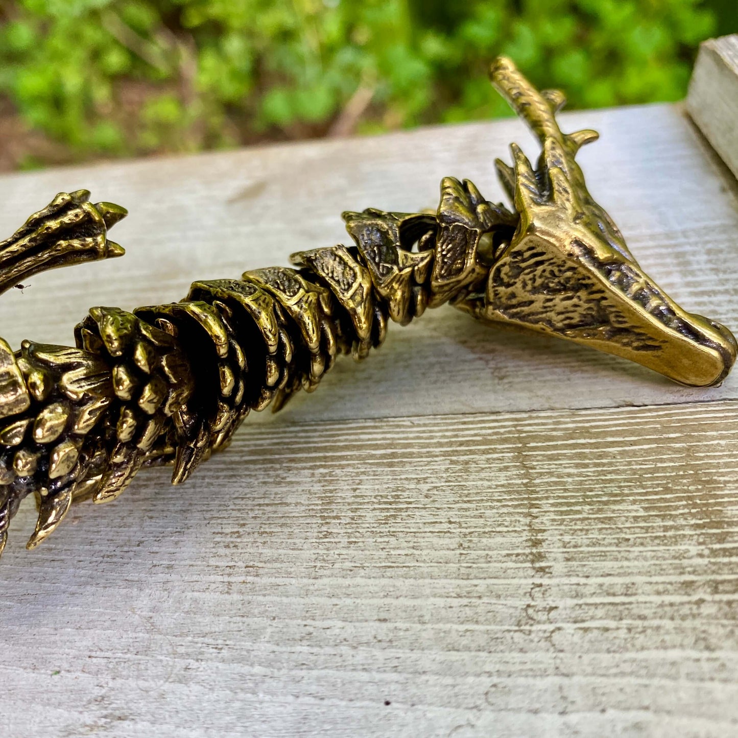 Solid brass large bendable dragon figurine by Wild Brass, emphasizing its detailed craftsmanship and symbolic design of power and wisdom.