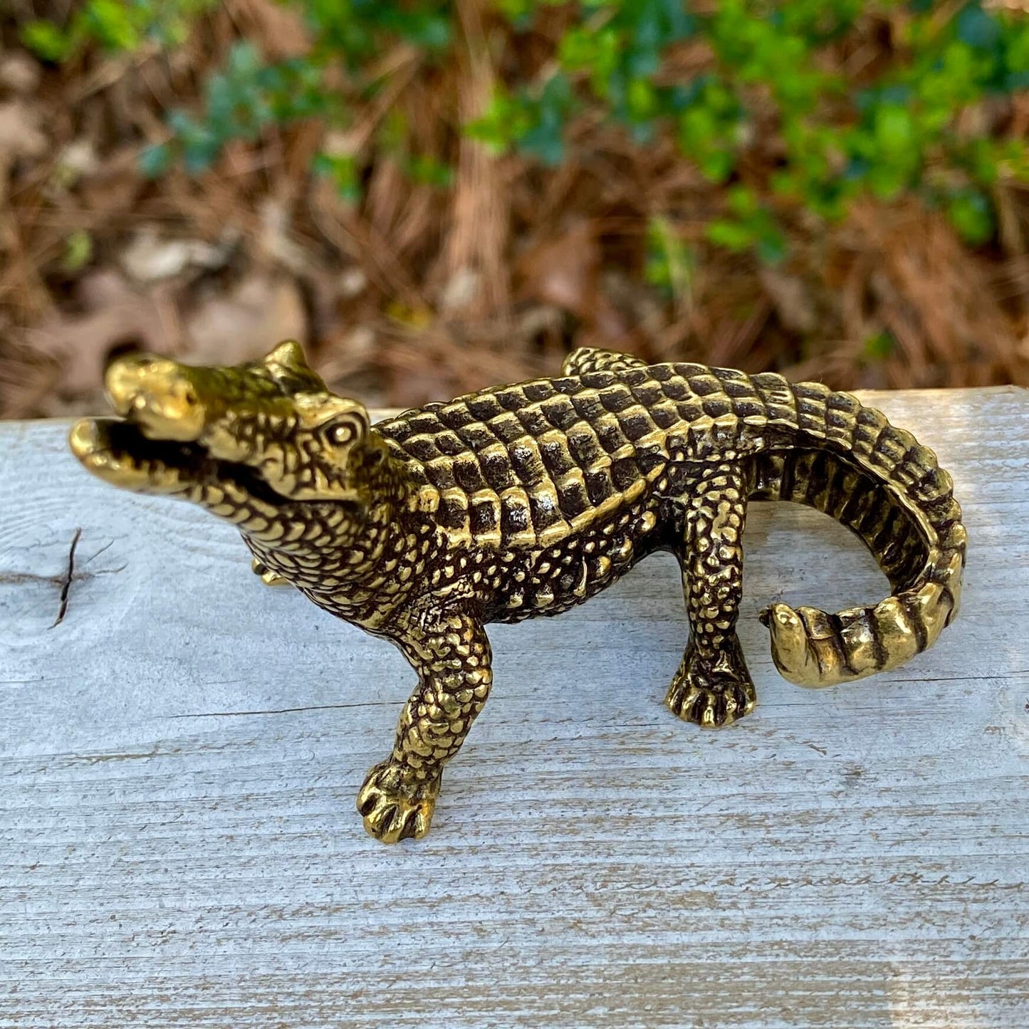 Solid brass alligator sculpture by Wild Brass, showcasing detailed texture and fierce expression symbolizing primal power and instincts.