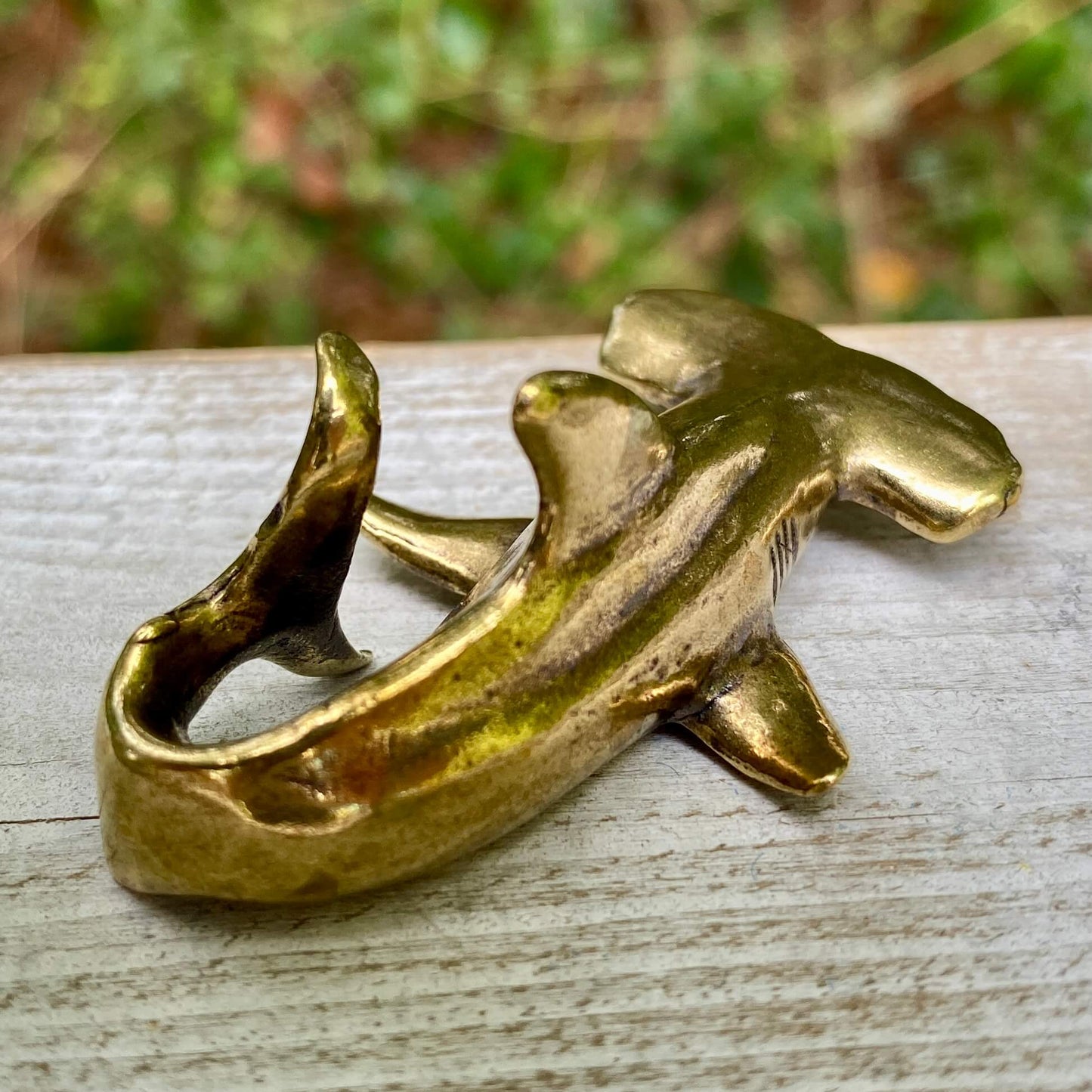 Solid brass hammerhead shark sculpture by Wild Brass, symbolizing perception, adaptability, and strength, with detailed features.