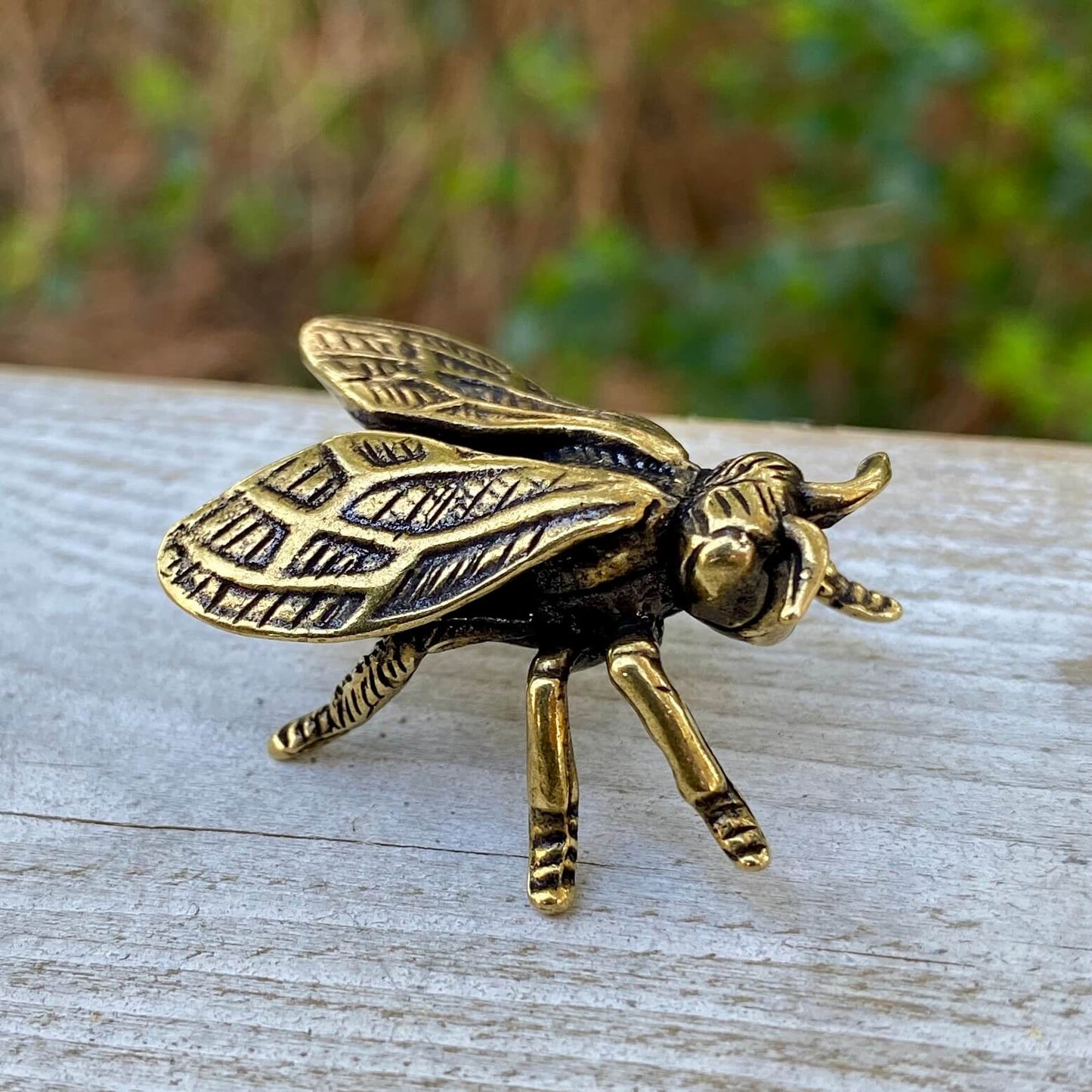Solid brass wasp sculpture by Wild Brass, symbolizing focus, precision, and discipline, displayed on a neutral background.