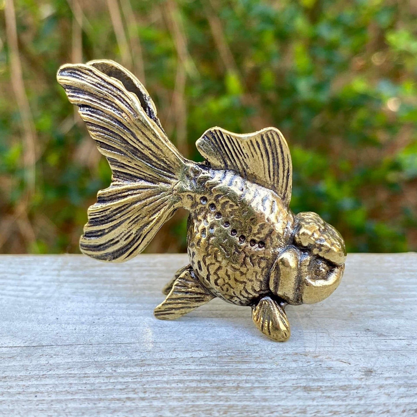 Solid brass goldfish sculpture by Wild Brass, symbolizing beauty, tranquility, and abundance, with detailed goldfish design.