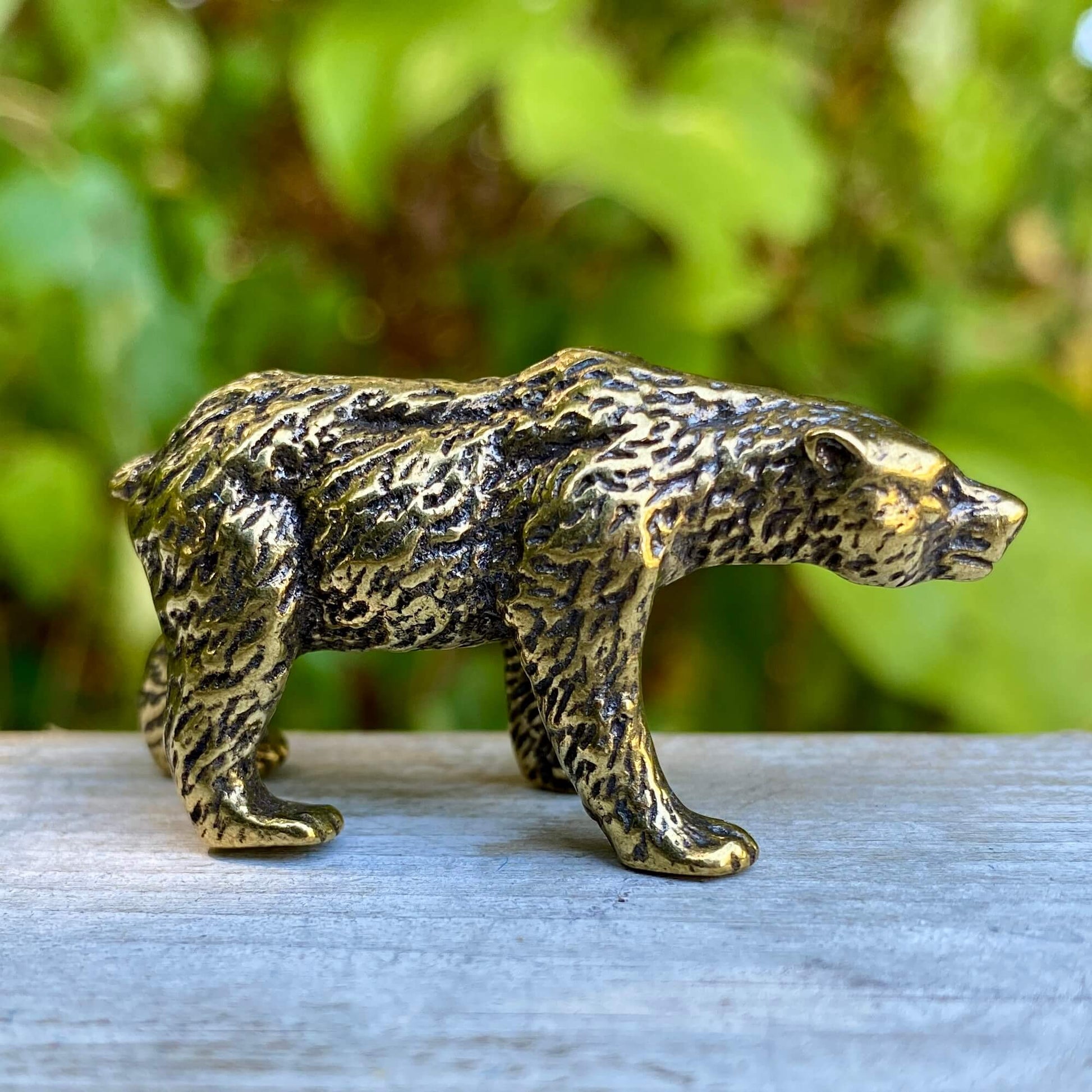 Solid brass bear symbol representing strength and protection, crafted by Wild Brass, shown in a detailed close-up image.