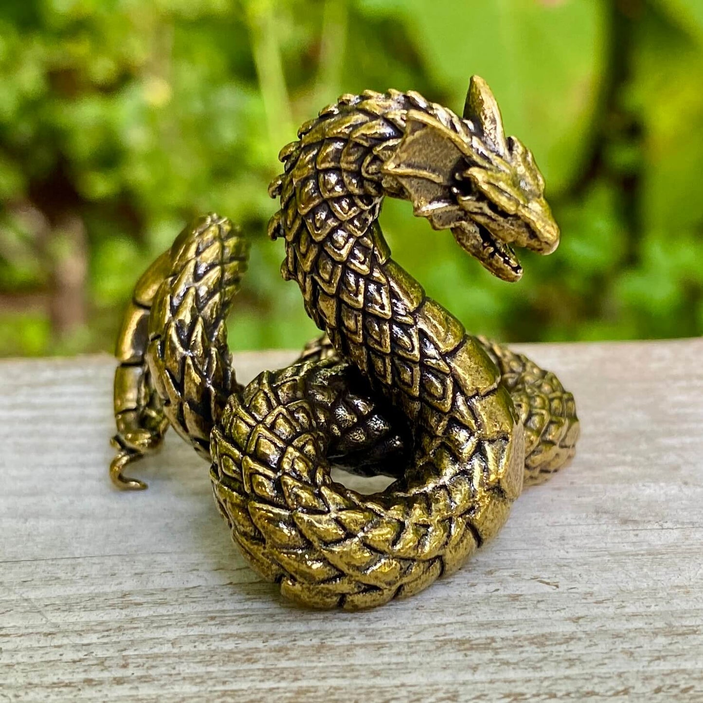 Solid brass Basilisk snake figurine by Wild Brass, symbol of protection, power, and transformation, detailed and polished surface.