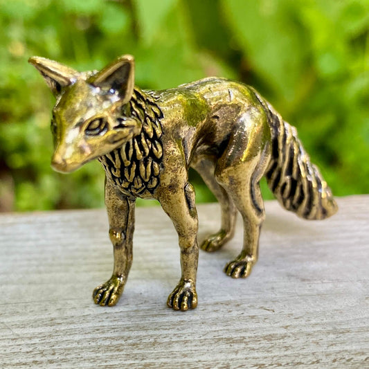 Solid brass fox sculpture by Wild Brass, symbolizing cleverness and adaptability, shown with intricate detailing on a neutral background.