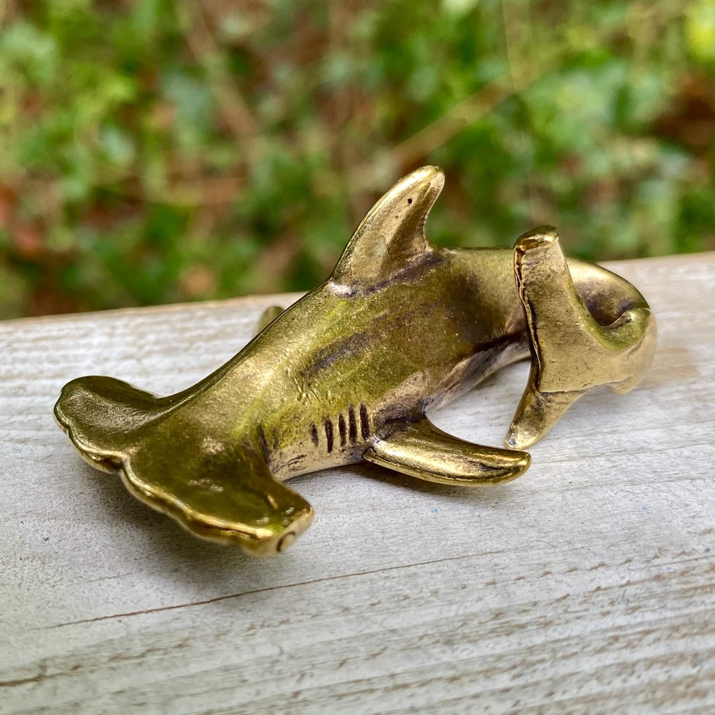 Solid brass hammerhead shark sculpture by Wild Brass, showcasing detailed fins and a sleek, polished finish.