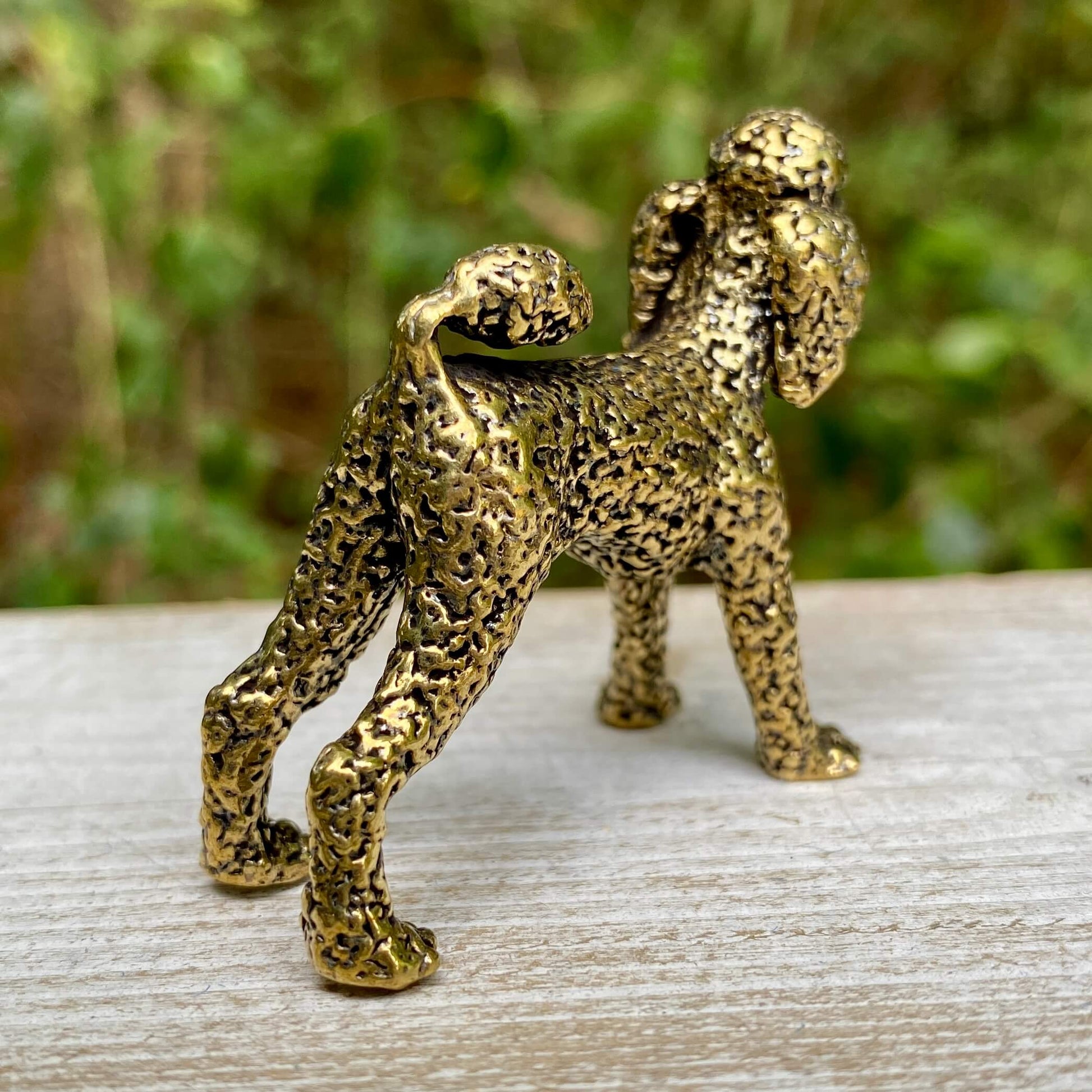 Solid brass poodle sculpture by Wild Brass, showcasing an elegant, detailed dog figure symbolizing loyalty and intelligence.
