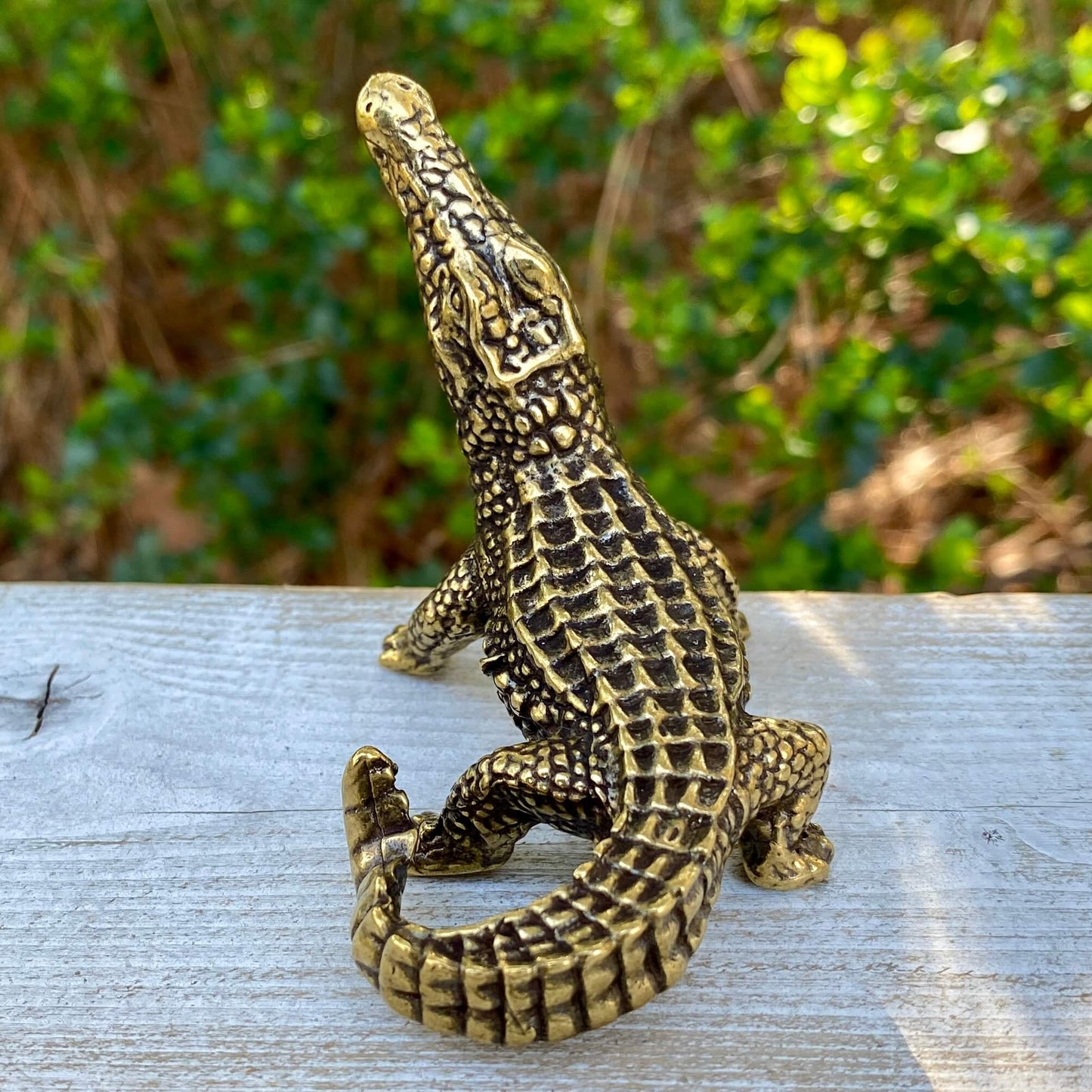 Solid brass alligator symbol from Wild Brass, showcasing a detailed alligator figure representing primal power and instinct.
