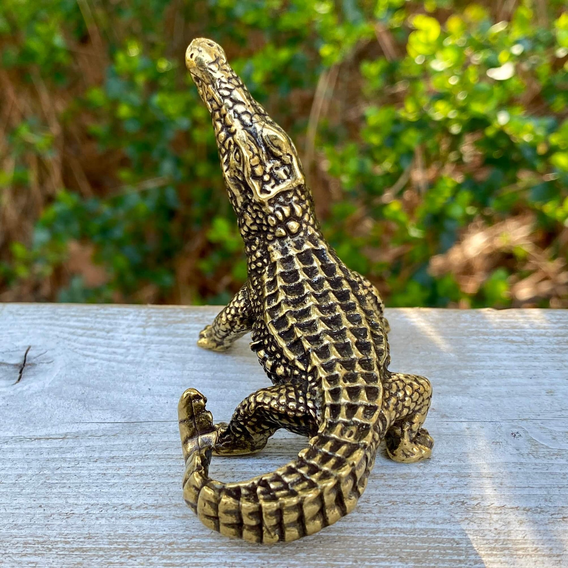 Solid brass alligator symbol from Wild Brass, showcasing a detailed alligator figure representing primal power and instinct.