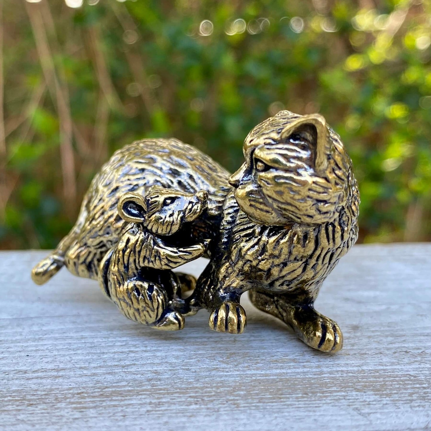 Solid brass cat and mouse figurines by Wild Brass, symbolizing balance, coexistence, and curiosity, displayed together.