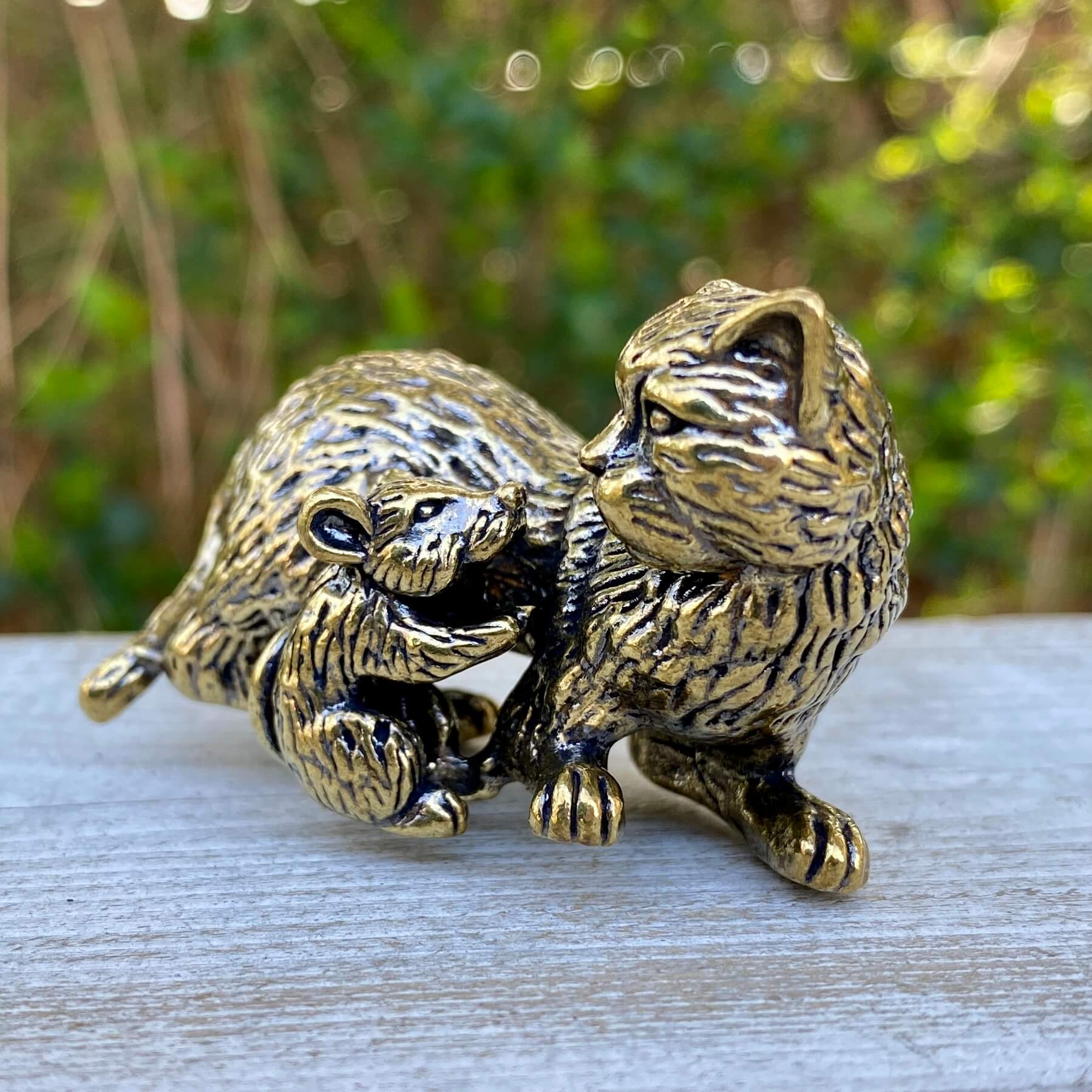 Solid brass cat and mouse figurines by Wild Brass, symbolizing balance, coexistence, and curiosity, displayed together.