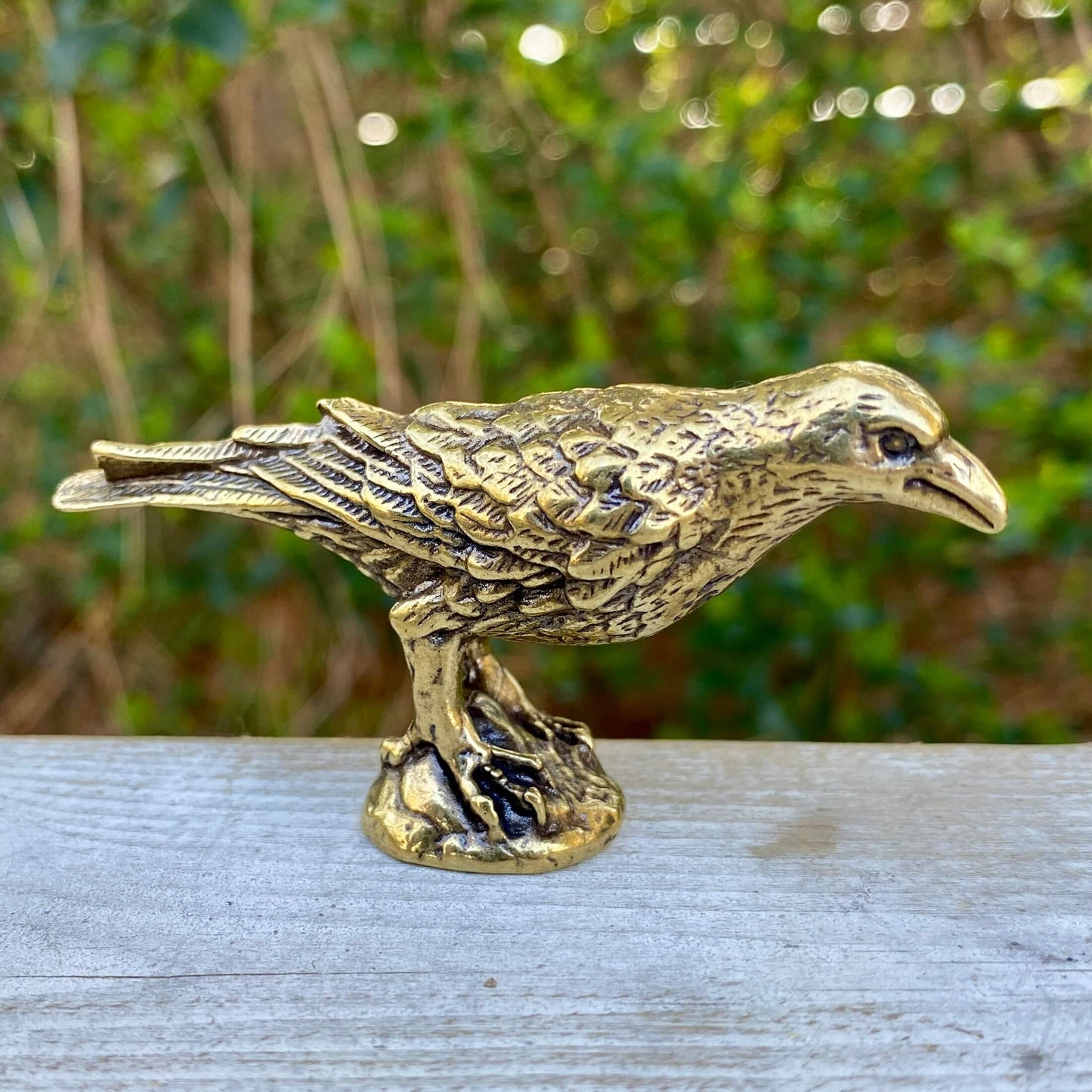 Solid brass raven sculpture by Wild Brass, symbol of intelligence, wisdom, and prophecy, detailed with a realistic raven figure.