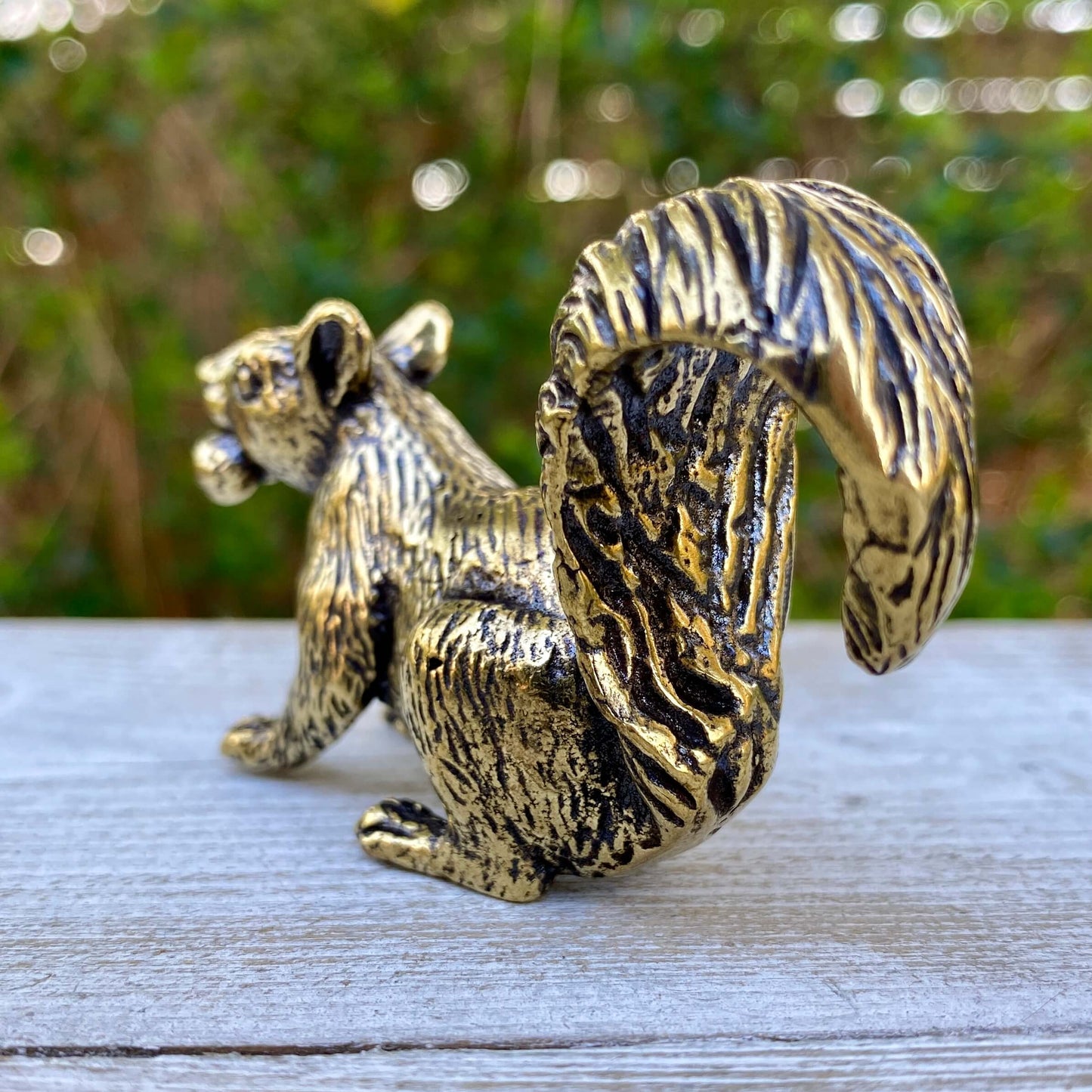 Solid brass squirrel figurine by Wild Brass, showcasing a playful squirrel symbolizing curiosity and joy, with detailed craftsmanship.
