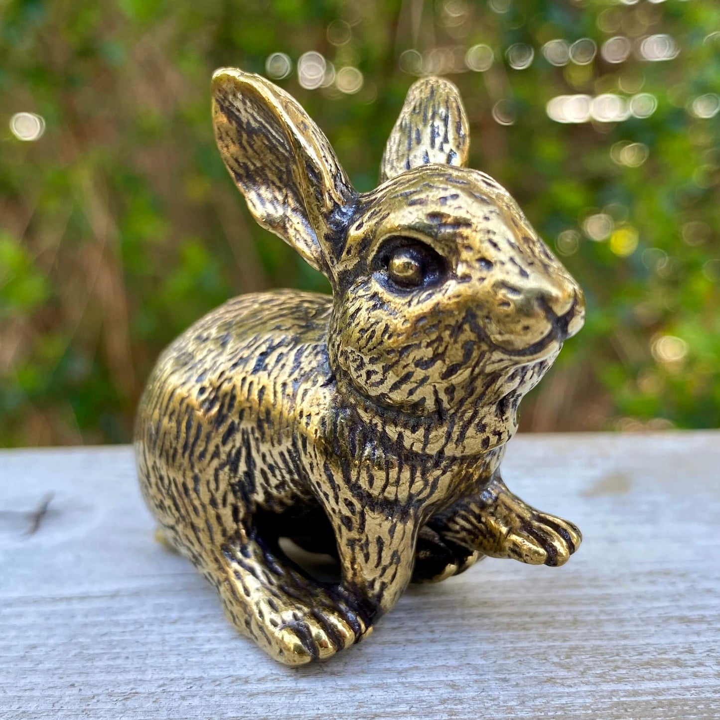 Solid brass rabbit figurine by Wild Brass, symbolizing gentleness, abundance, and good fortune, shown on a neutral background.