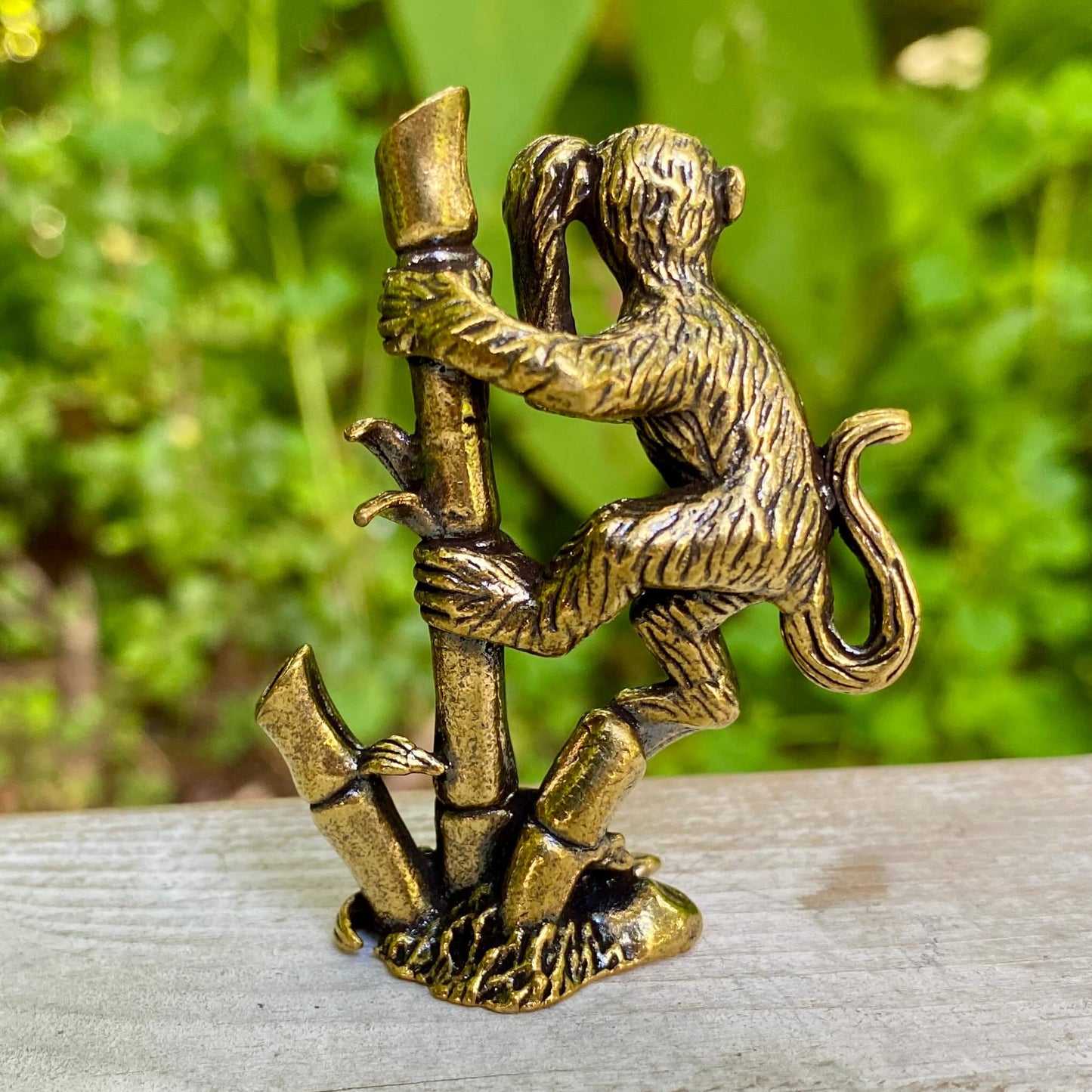 Solid brass monkey sculpture on bamboo stand, symbolizing balance, joy, and harmony, by Wild Brass.