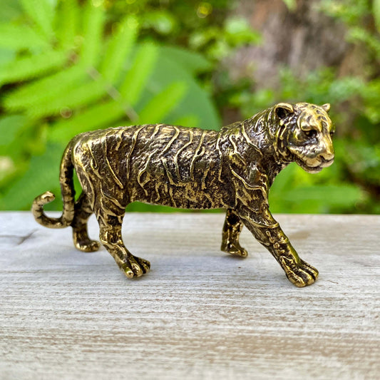 Solid brass tiger sculpture by Wild Brass, symbol of power, passion, and independence, displayed with detailed craftsmanship.