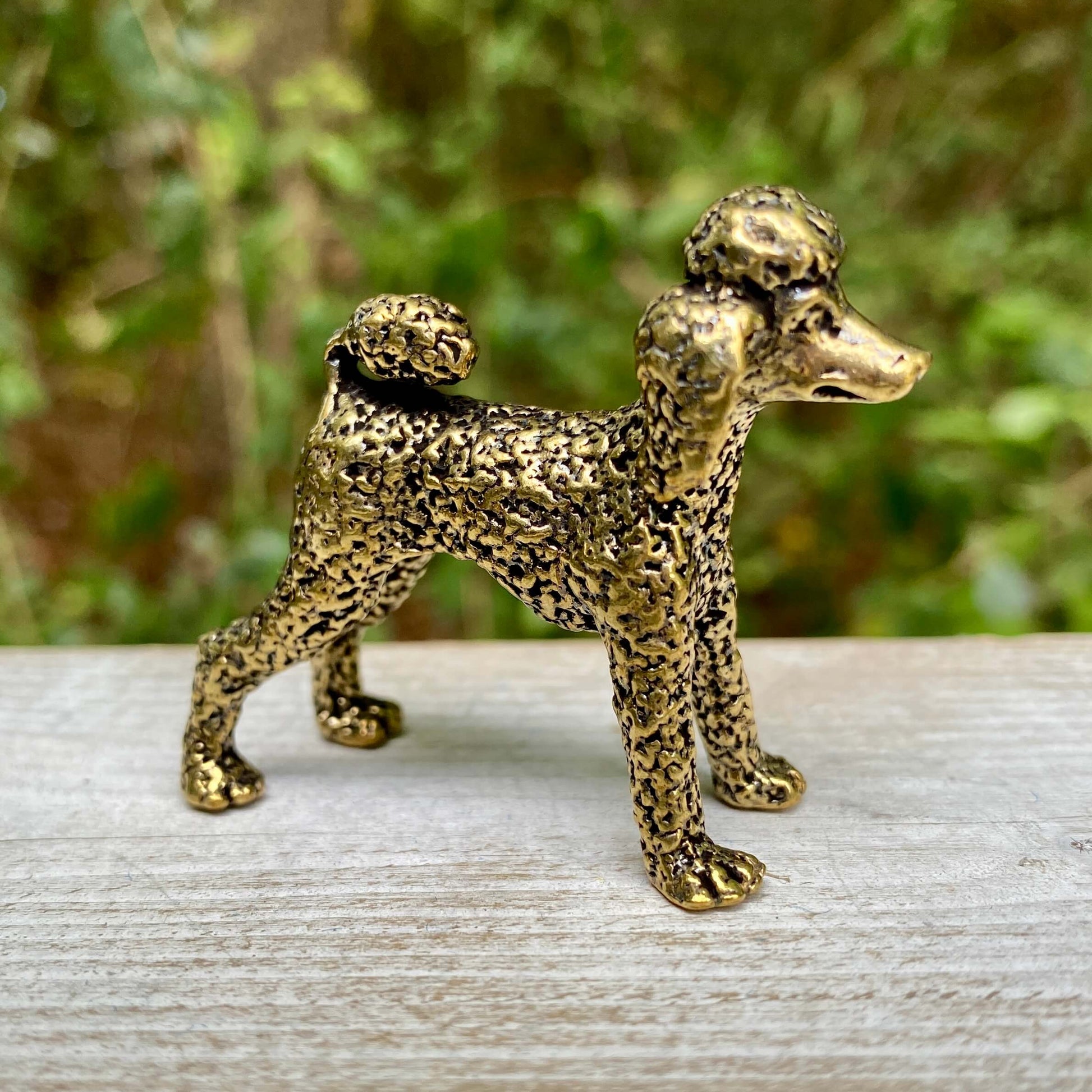 Solid brass poodle figurine by Wild Brass, showcasing an elegant, detailed poodle sculpture symbolizing intelligence and loyalty.