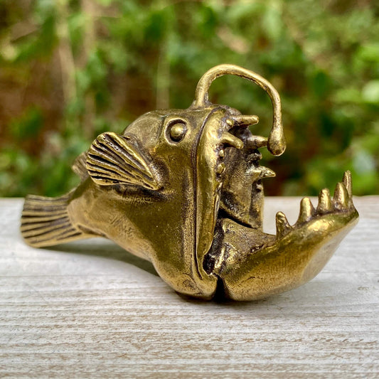 Solid brass angler fish sculpture by Wild Brass, representing mystery, adaptability, and inner light with detailed craftsmanship.
