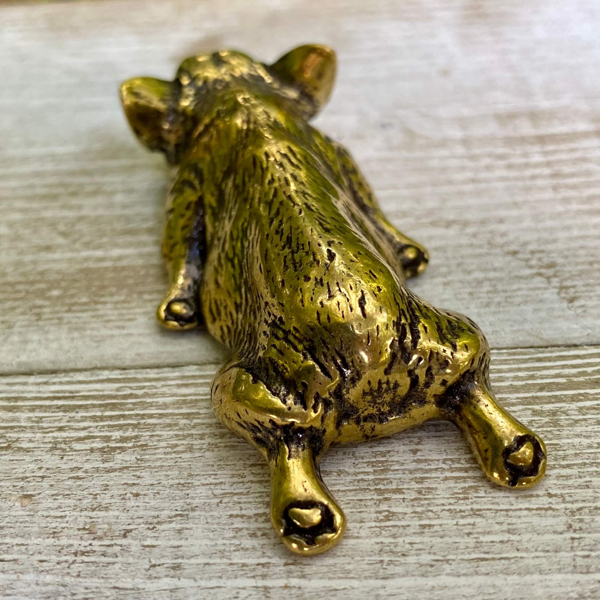 Solid brass Corgi dog figurine by Wild Brass, symbol of joy, loyalty, and playful spirit, displayed on a plain background.
