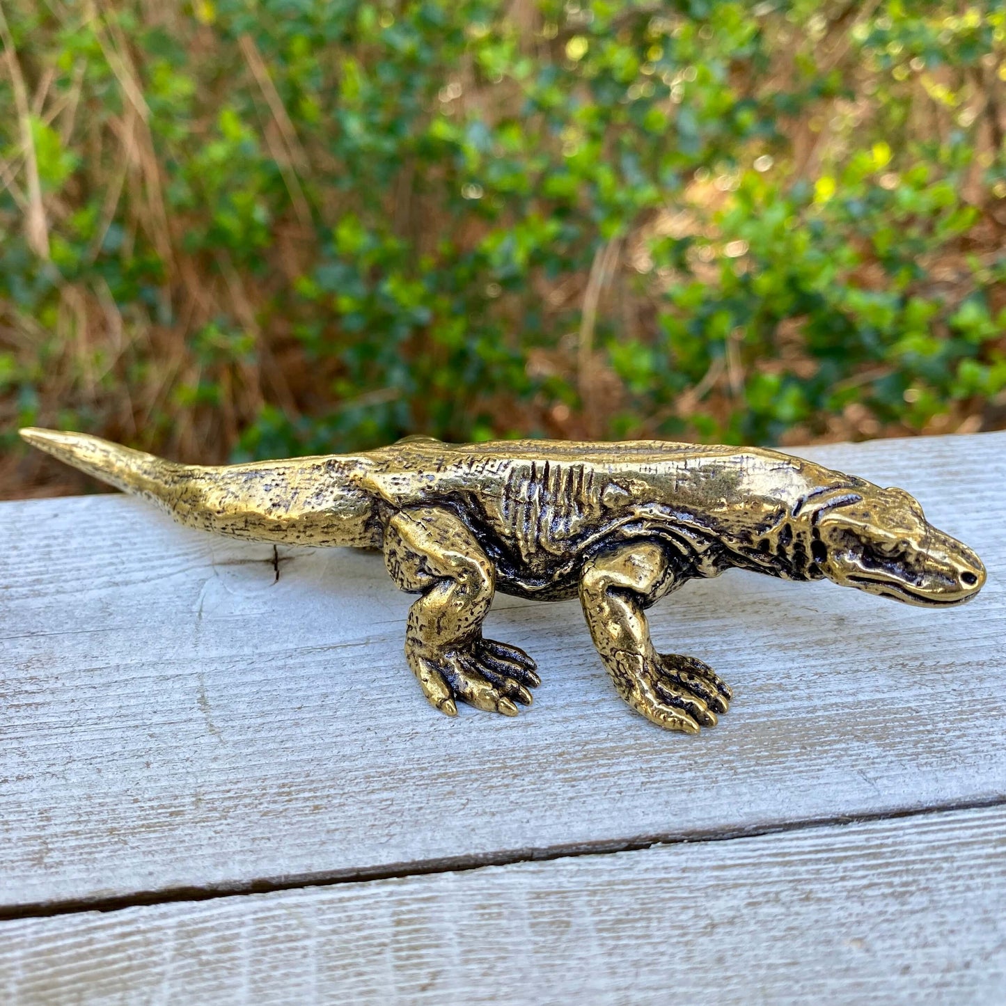 Solid brass Komodo dragon figurine by Wild Brass, showcasing intricate details and a fierce, lifelike posture symbolizing strength and wisdom.