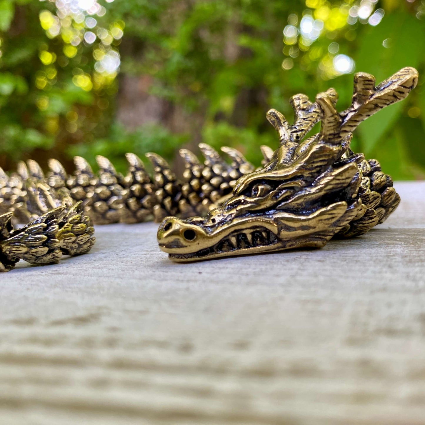 Wild Brass solid brass large bendable dragon sculpture, detailed with a powerful, wise dragon design symbolizing transformation.