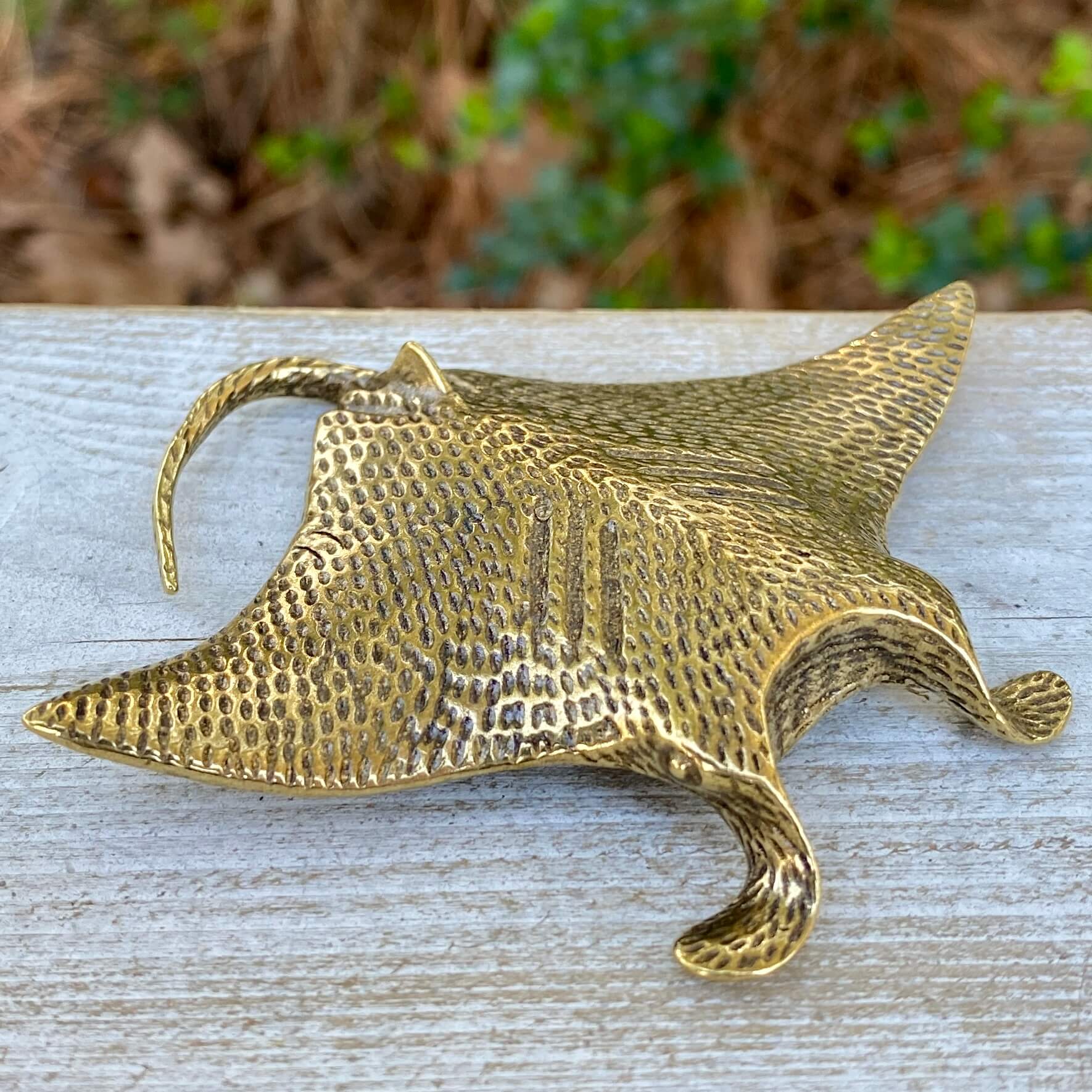 Solid brass manta ray sculpture by Wild Brass, showcasing graceful wings and detailed features symbolizing freedom and wonder.