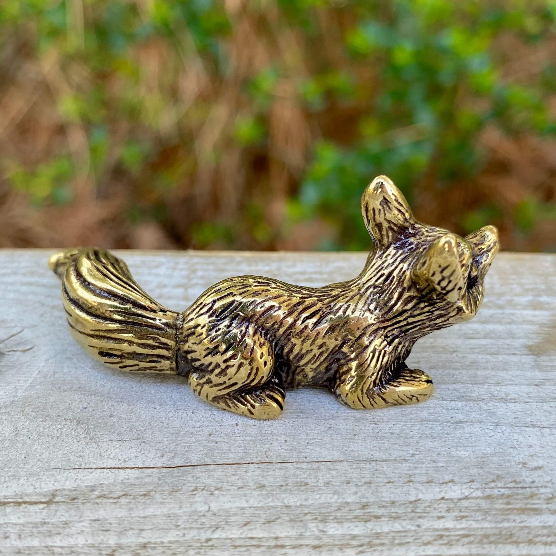 Solid brass fox figurine crouching, symbol of cleverness and adaptability, by Wild Brass.