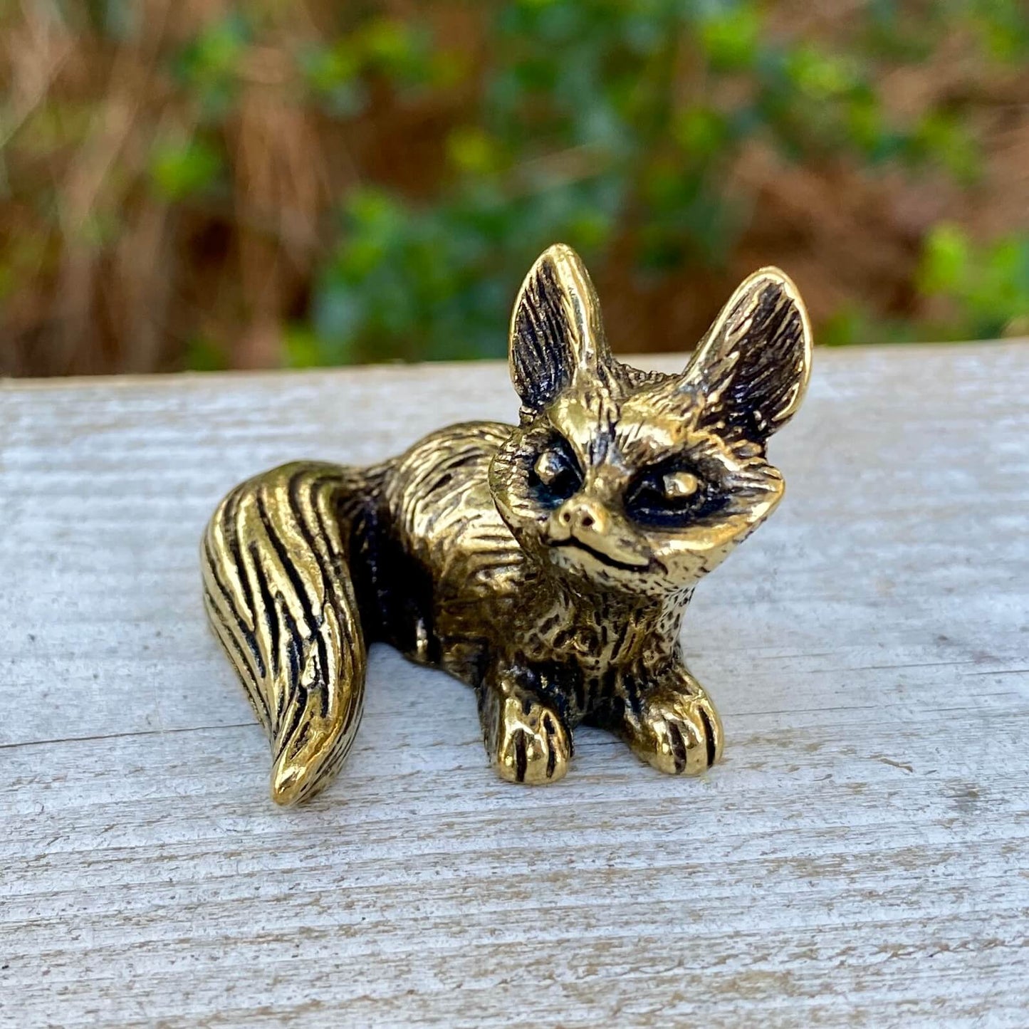 Solid brass fox figurine by Wild Brass, sitting with alert ears and detailed craftsmanship, symbolizing cleverness and adaptability.