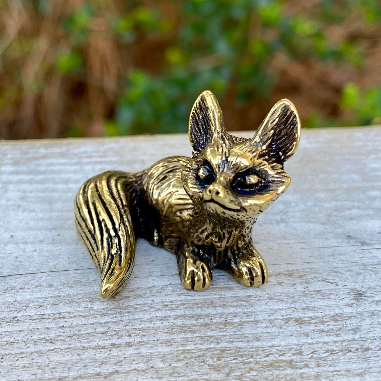 Solid brass fox figurine by Wild Brass, sitting with alert ears and detailed craftsmanship, symbolizing cleverness and adaptability.