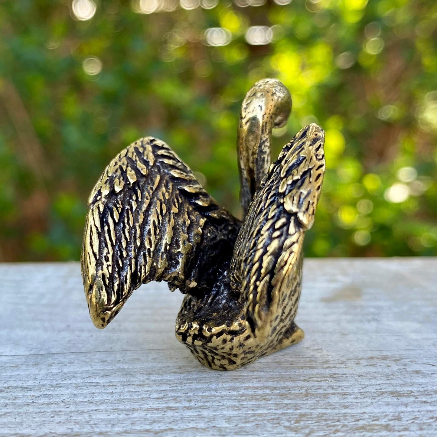 Solid brass swan figurine by Wild Brass, showcasing a graceful and elegant bird with intricate detailing and a smooth polished finish.