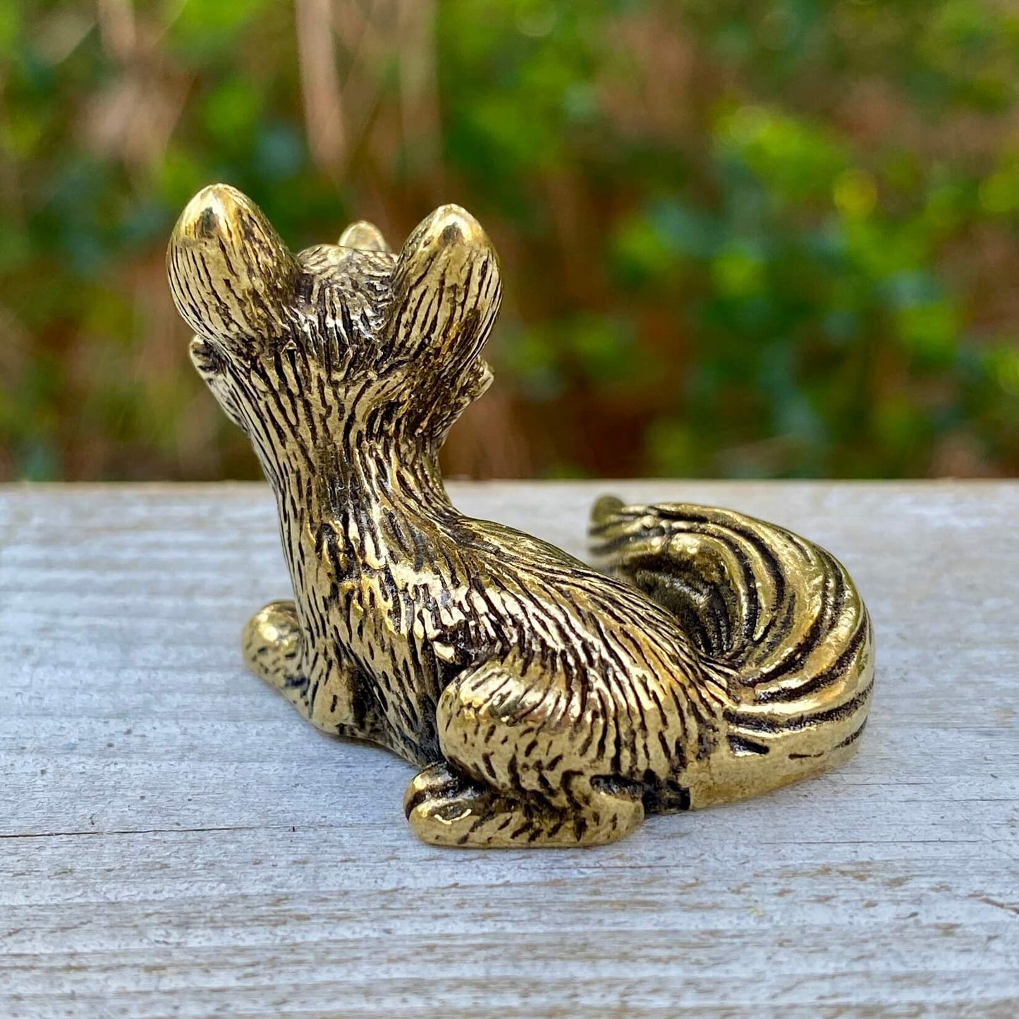Solid brass fox figurine from Wild Brass, sitting with alert ears, symbolizing cleverness and adaptability.