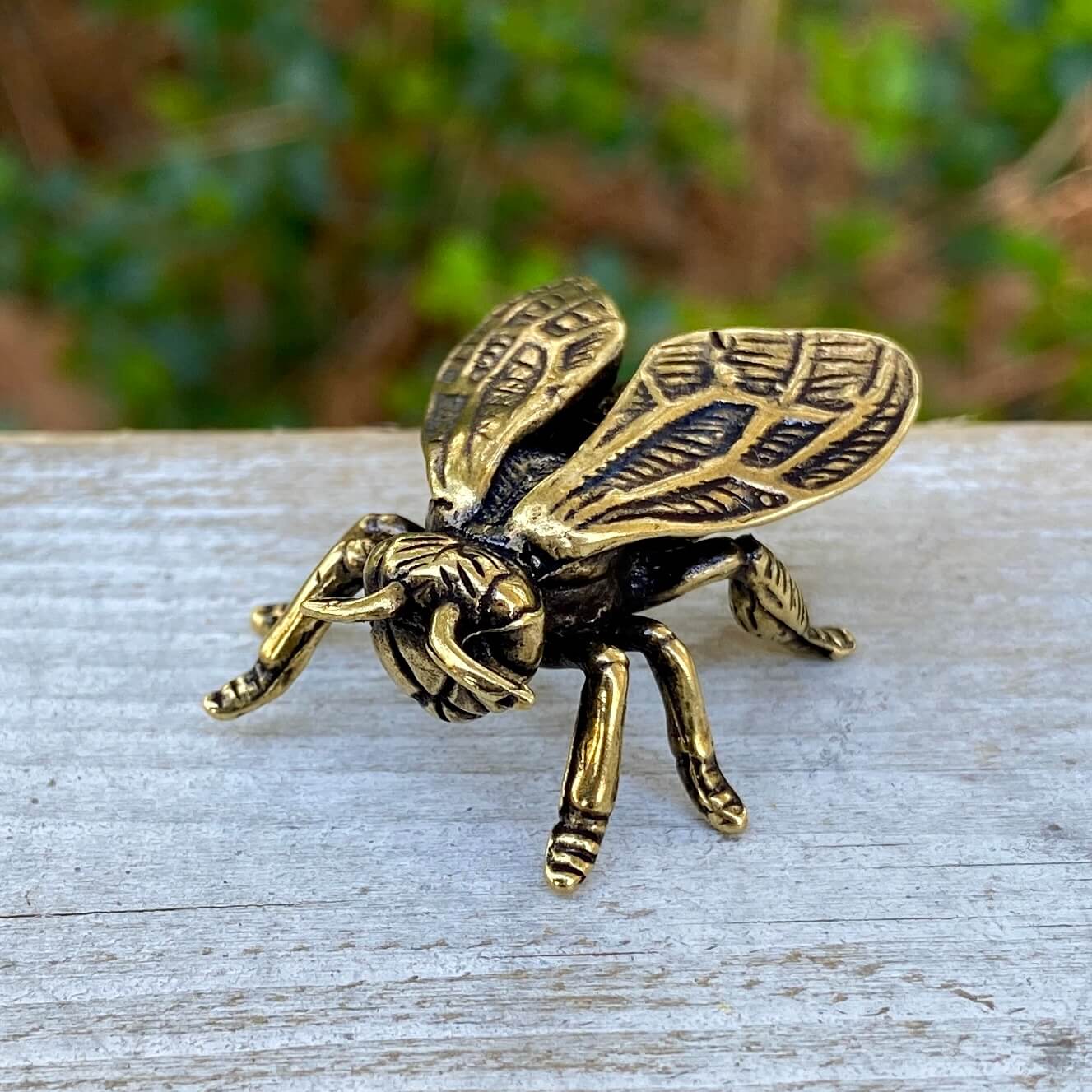 Solid brass wasp sculpture by Wild Brass, symbolizing focus, precision, and discipline, with detailed wings and body.