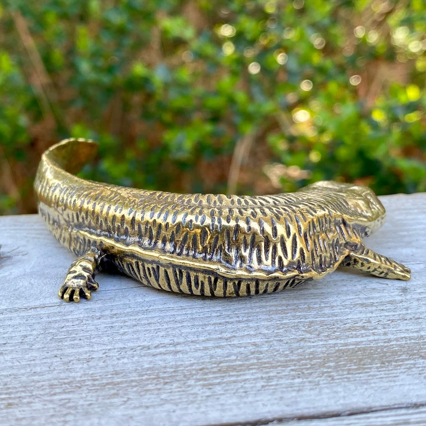 Solid brass salamander sculpture by Wild Brass, symbol of resilience and rebirth, featuring intricate details and a polished finish.