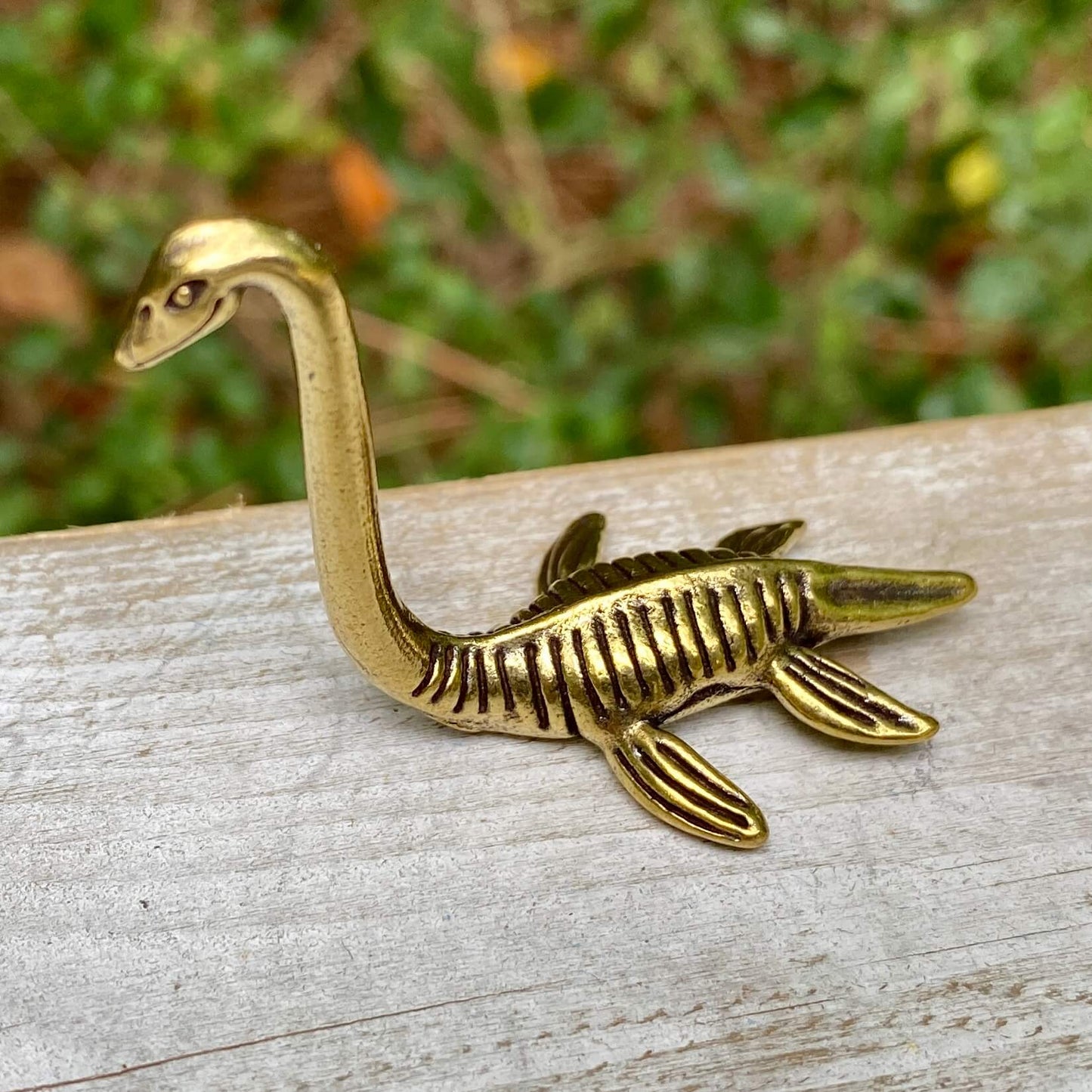 Solid brass Loch Ness Monster figurine by Wild Brass, featuring a mythical sea creature with intricate detailing.