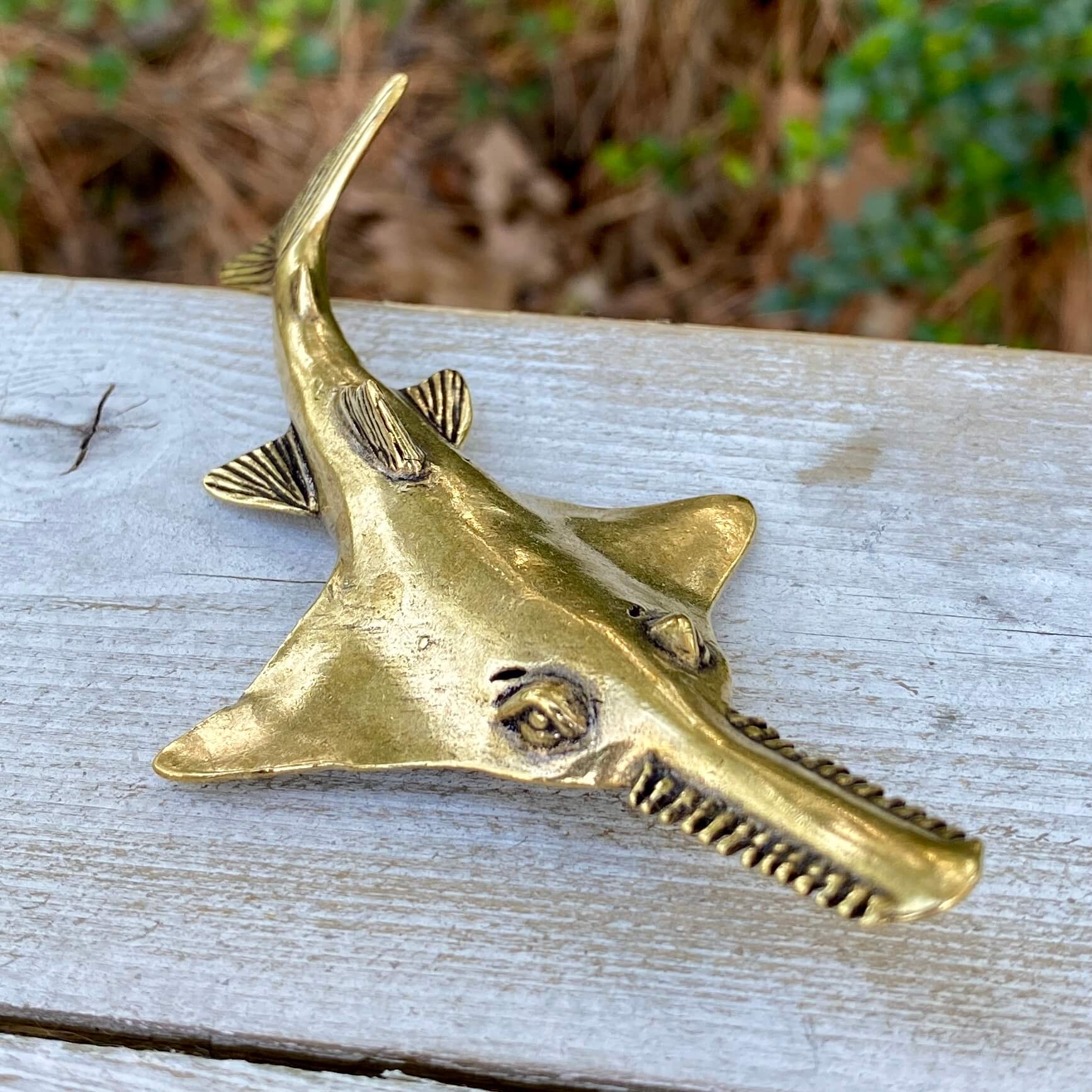 Solid brass sawfish sculpture by Wild Brass, symbol of focus, power, and mystery, featuring detailed craftsmanship and a sleek finish.
