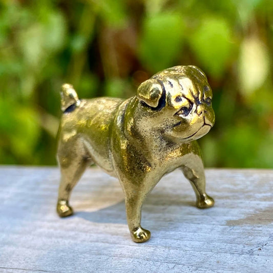 Solid brass pug figurine by Wild Brass, symbol of devotion, charm, and good fortune, shown with detailed features and polished finish.