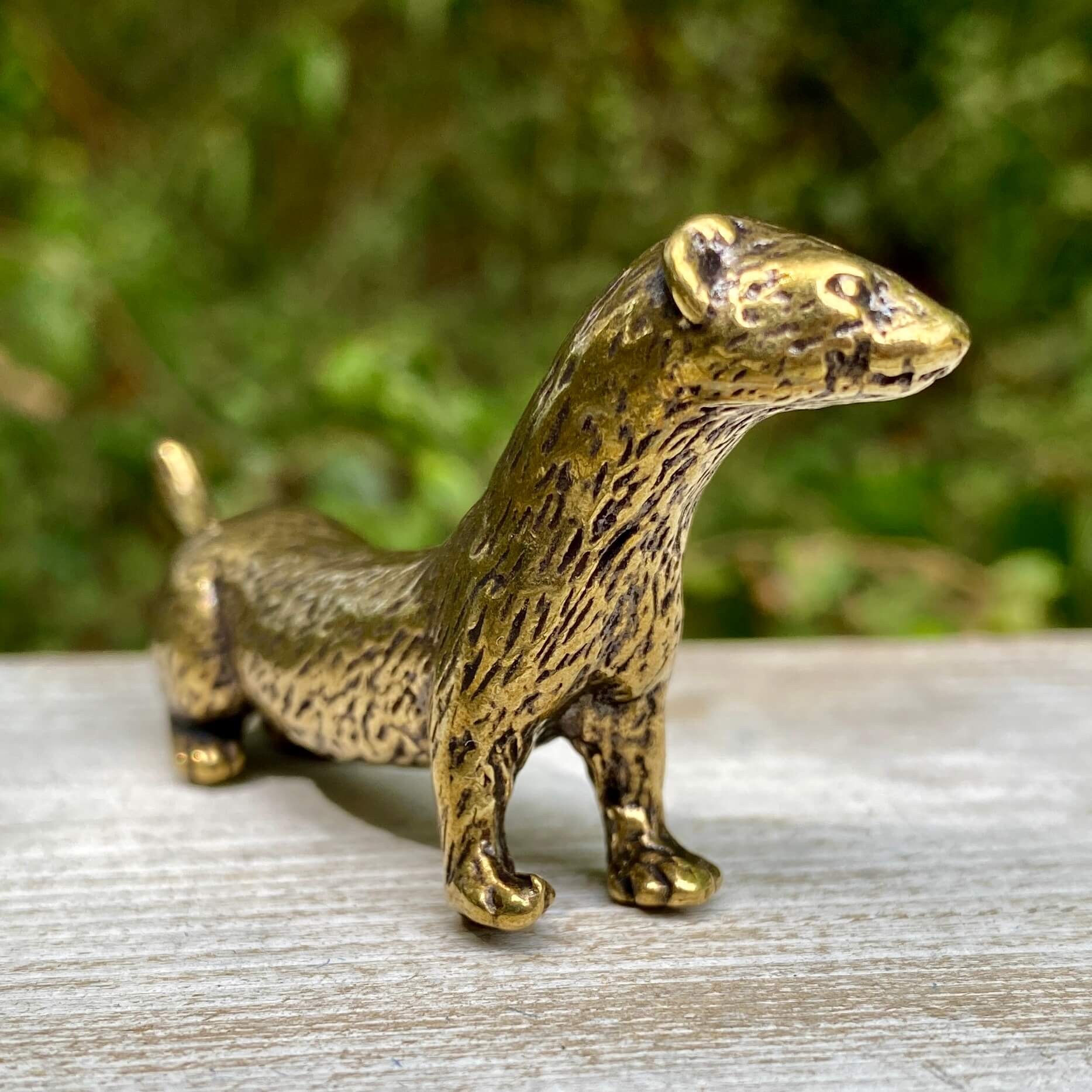 Solid brass weasel figurine by Wild Brass, showcasing a sleek, detailed design symbolizing cunning and agility.