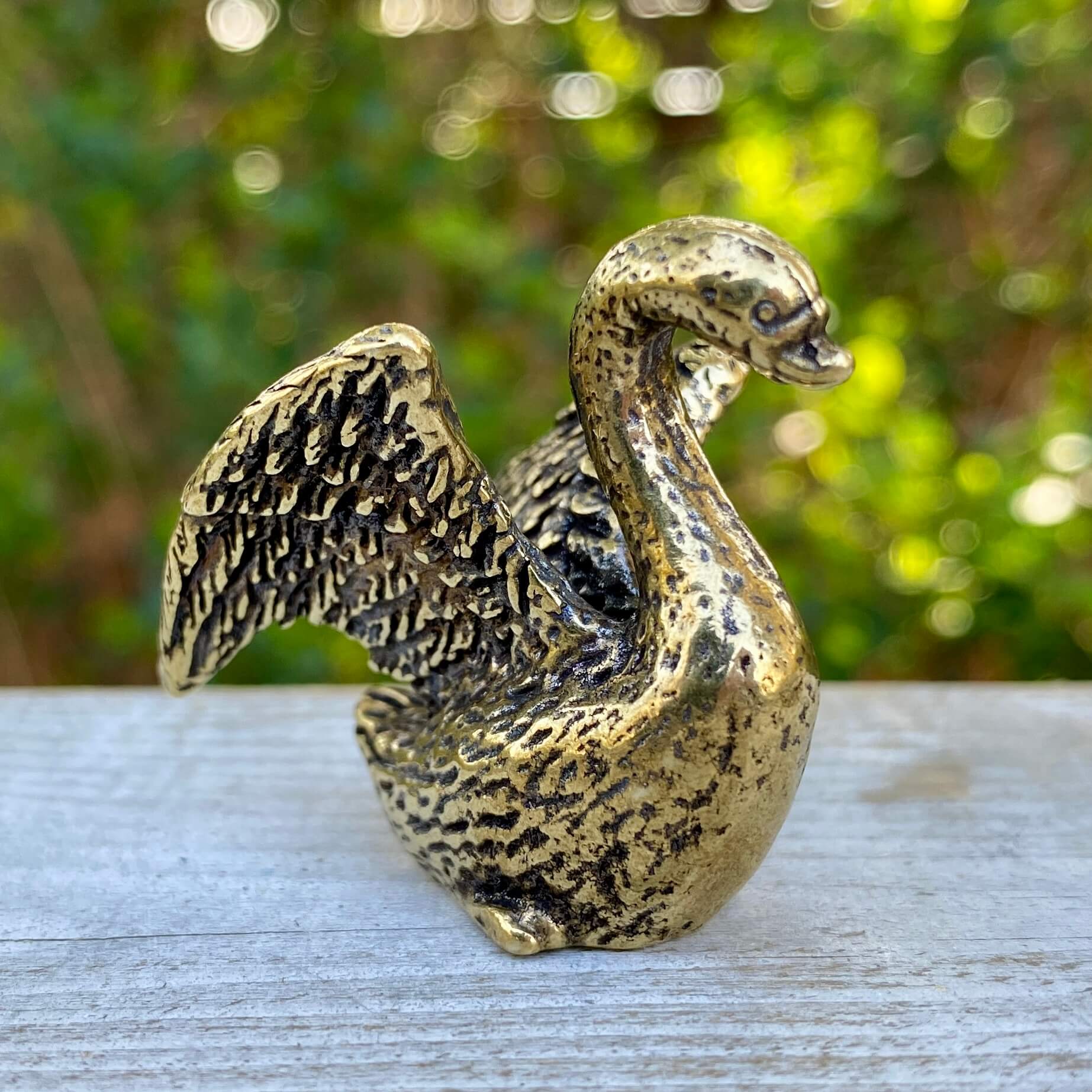 Solid brass swan sculpture by Wild Brass, showcasing a graceful and elegant design symbolizing beauty and serenity.
