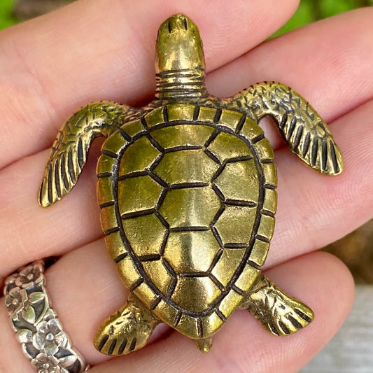 Solid brass sea turtle figurine by Wild Brass, symbol of longevity, wisdom, and endurance, with detailed shell and flipper design.