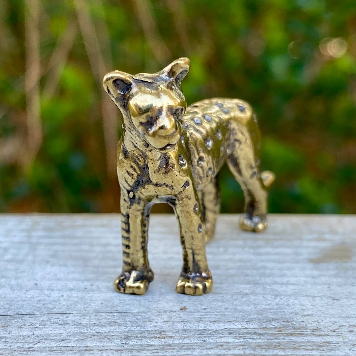 Solid brass leopard figurine by Wild Brass, showcasing a graceful and powerful feline sculpture with intricate details.