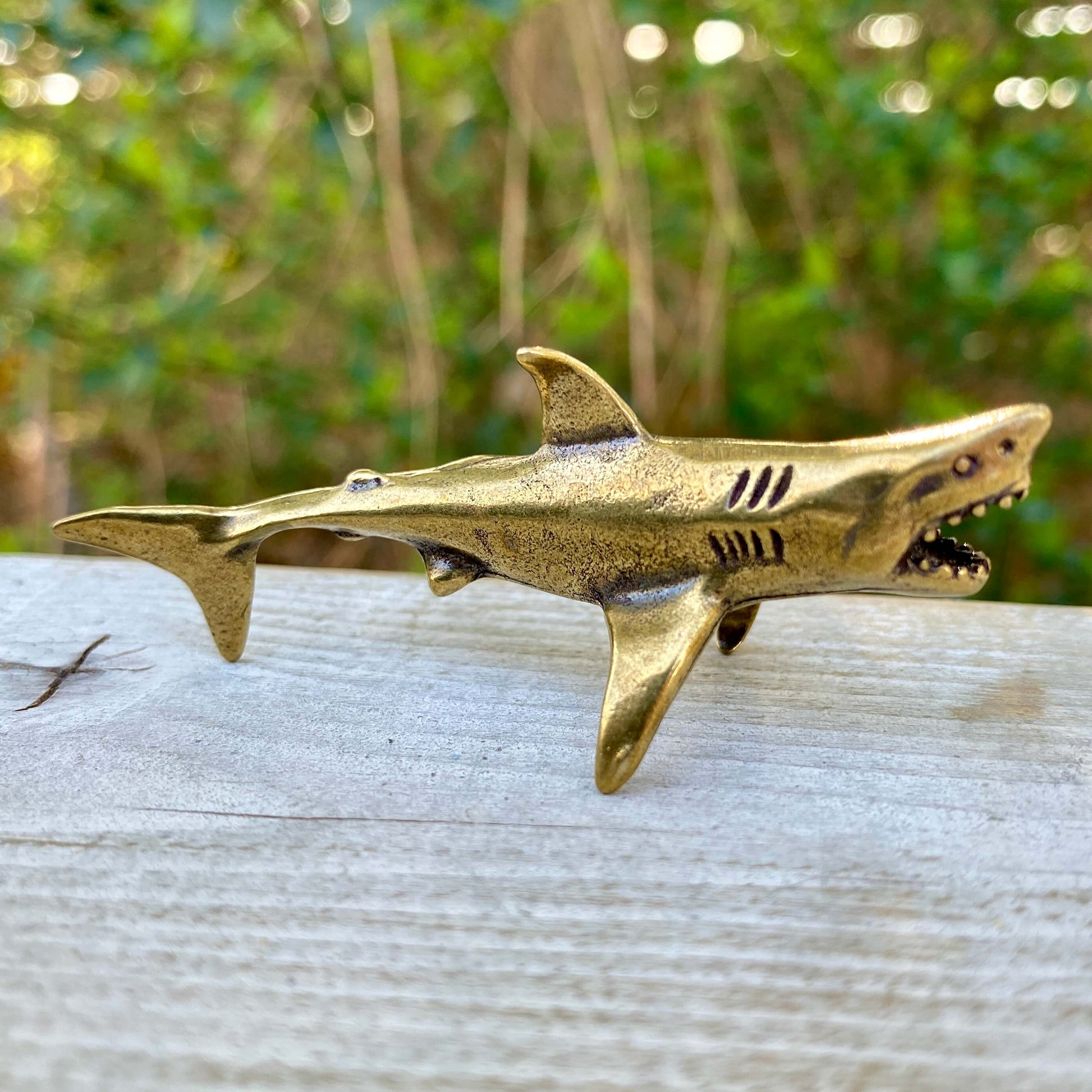 Solid brass shark figurine by Wild Brass, symbolizing power, agility, and strength, with detailed shark design.