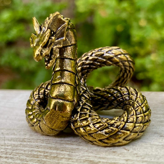 Solid brass basilisk snake sculpture by Wild Brass, symbolizing protection, power, and transformation, detailed and polished design.