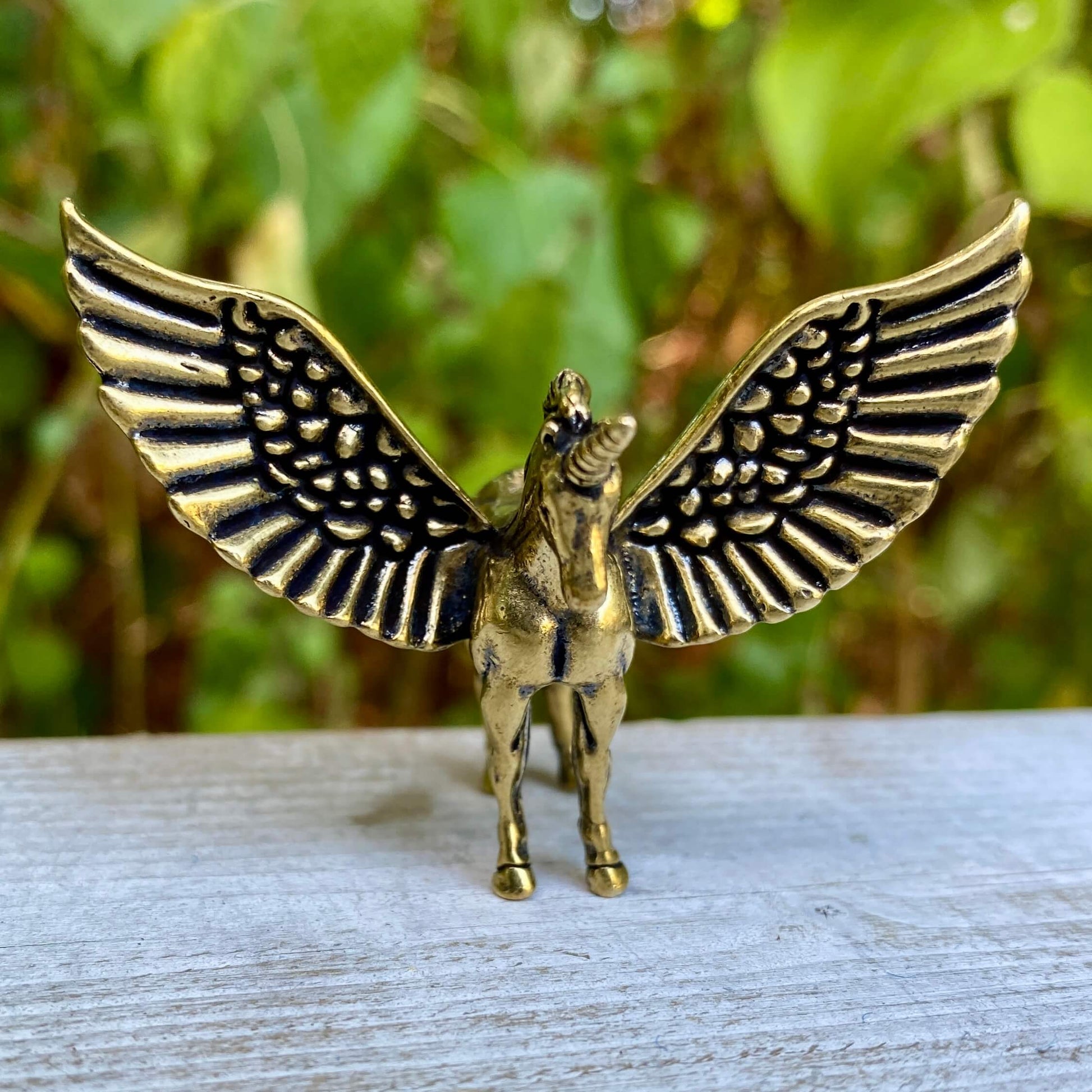 Solid brass Pegasus sculpture by Wild Brass featuring detailed wings and dynamic pose, symbolizing freedom and divine power.