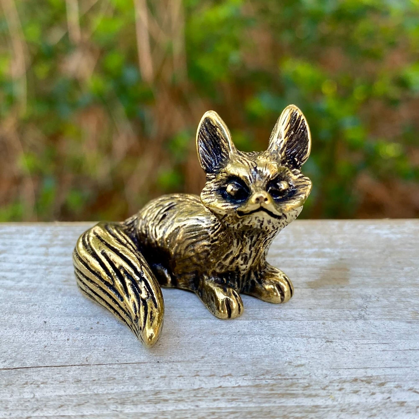 Solid brass fox figurine by Wild Brass, sitting symbol of cleverness, adaptability, and trickery, detailed and polished finish.