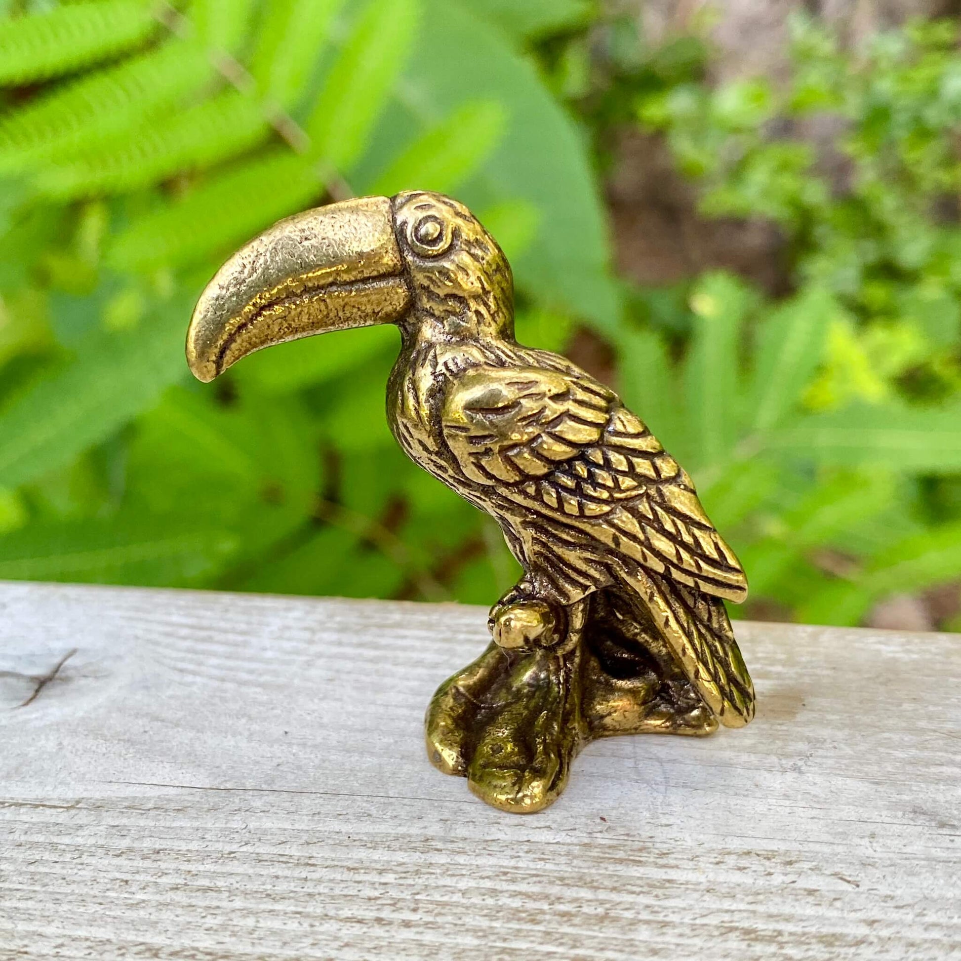 Solid brass toucan bird sculpture by Wild Brass, showcasing vibrant colors and playful design symbolizing communication and vibrancy.