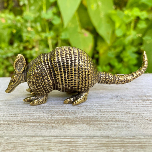 Solid brass armadillo sculpture by Wild Brass, symbol of protection and resilience, with detailed textured surface.