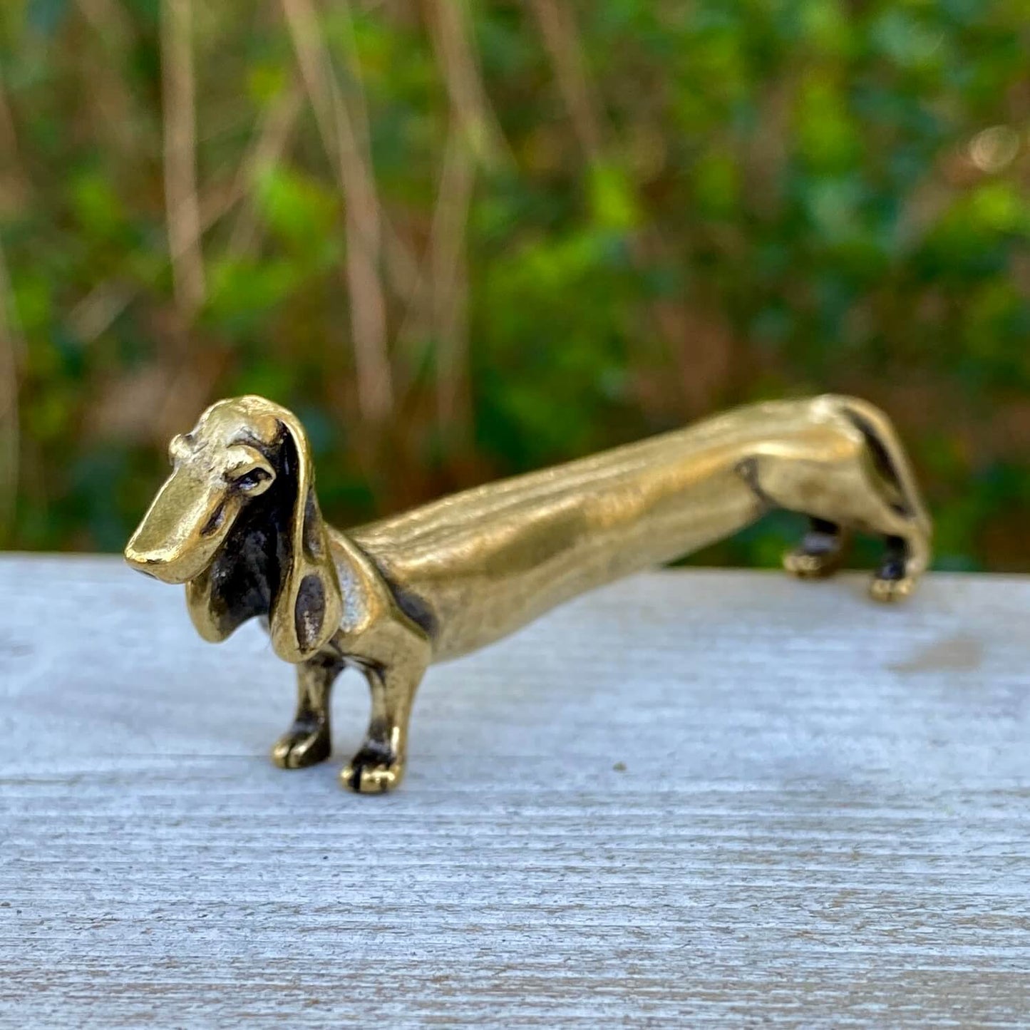 Solid brass Dachshund dog sculpture by Wild Brass, symbol of courage, loyalty, and tenacity, detailed long dog figurine.