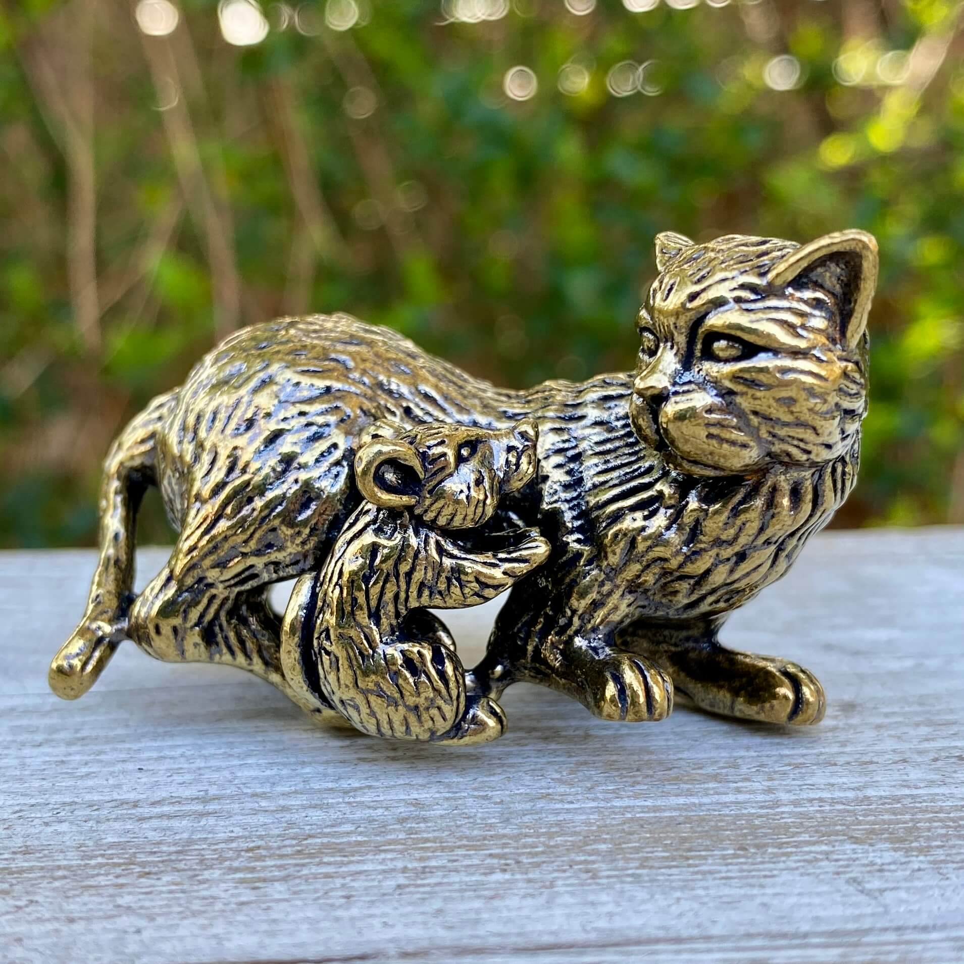 Solid brass cat and mouse figurines by Wild Brass, symbolizing balance, coexistence, and curiosity, displayed together on a surface.